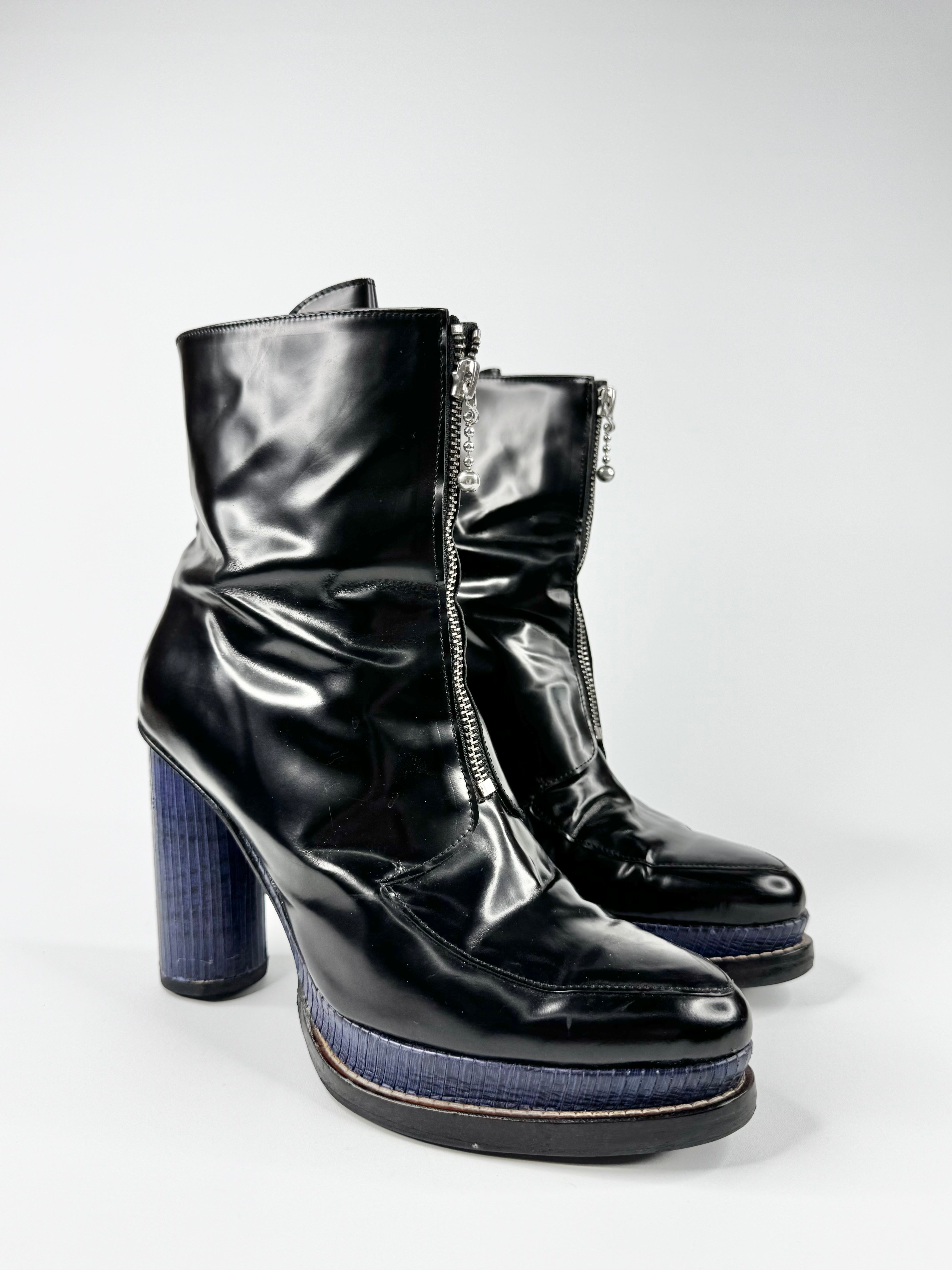Black patent leather boots with platform sole on a white background