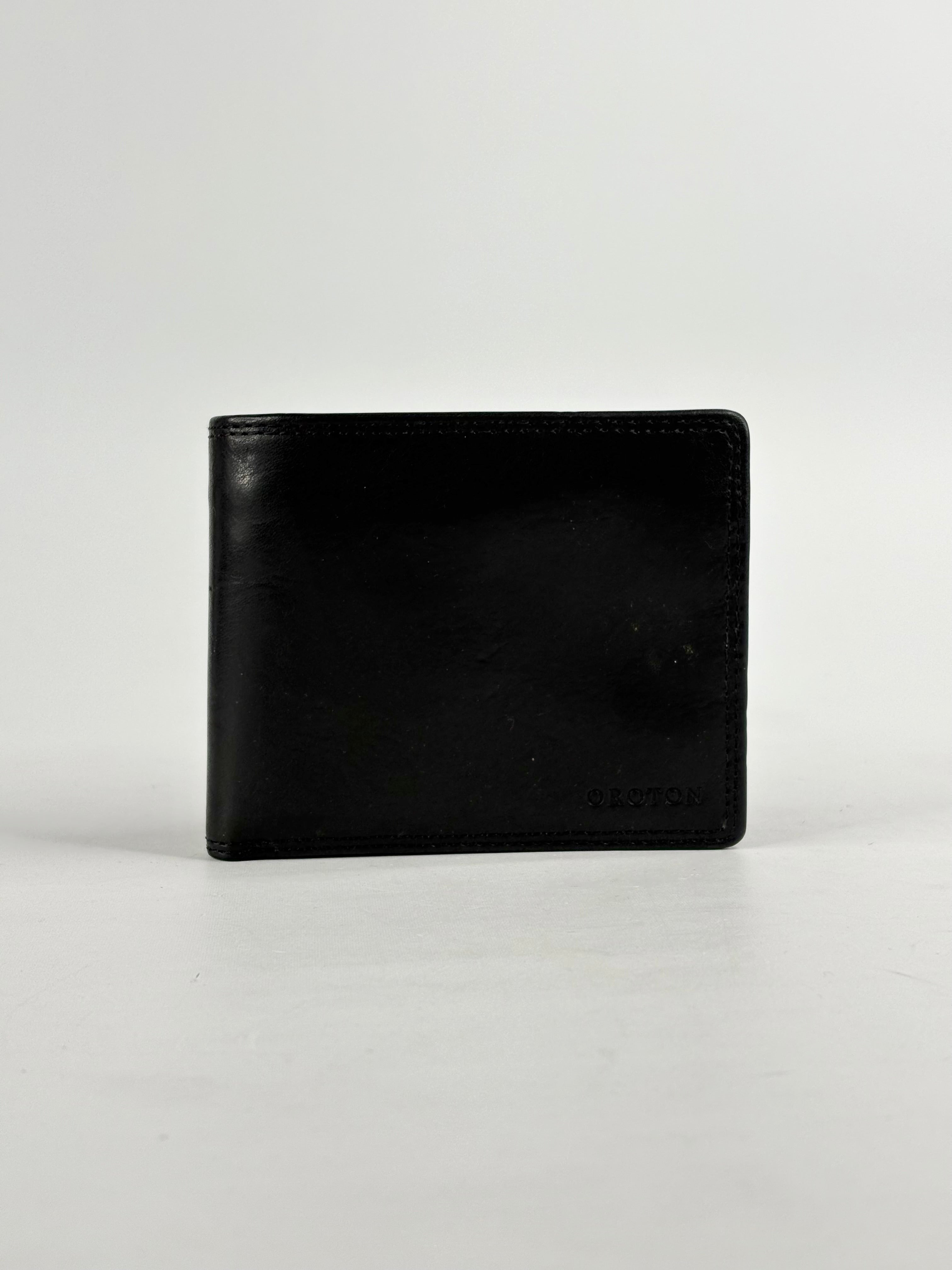 Black leather wallet on a light gray background