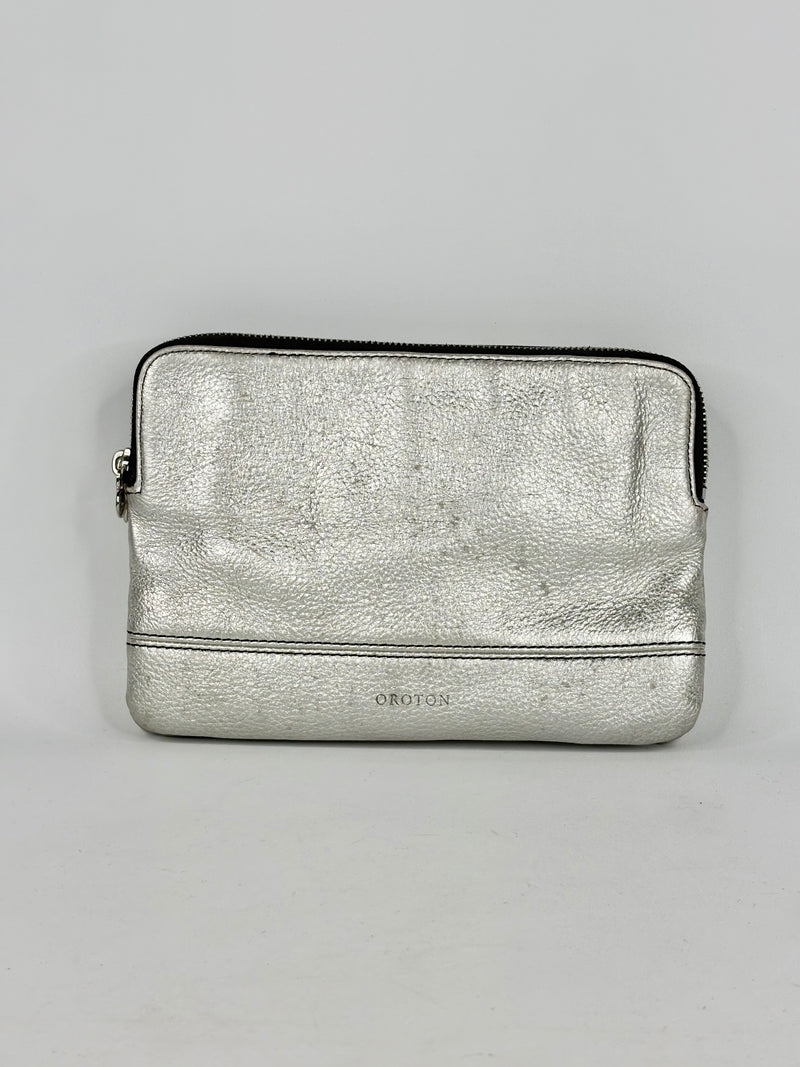 Silver metallic pouch with a brand logo on a gray background