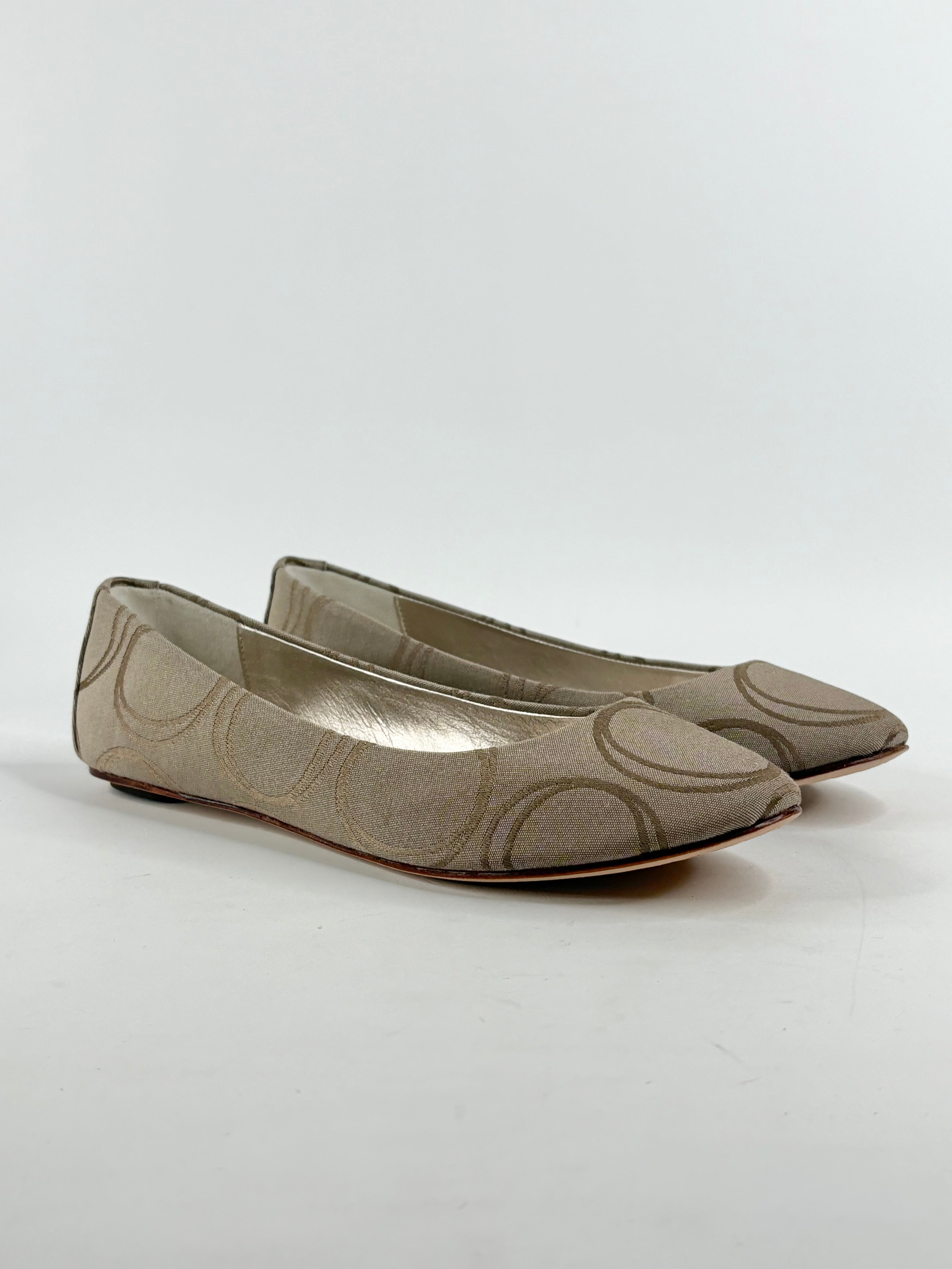 A pair of taupe colored Oroton ballet flats with a jacquard design, presented new in box.