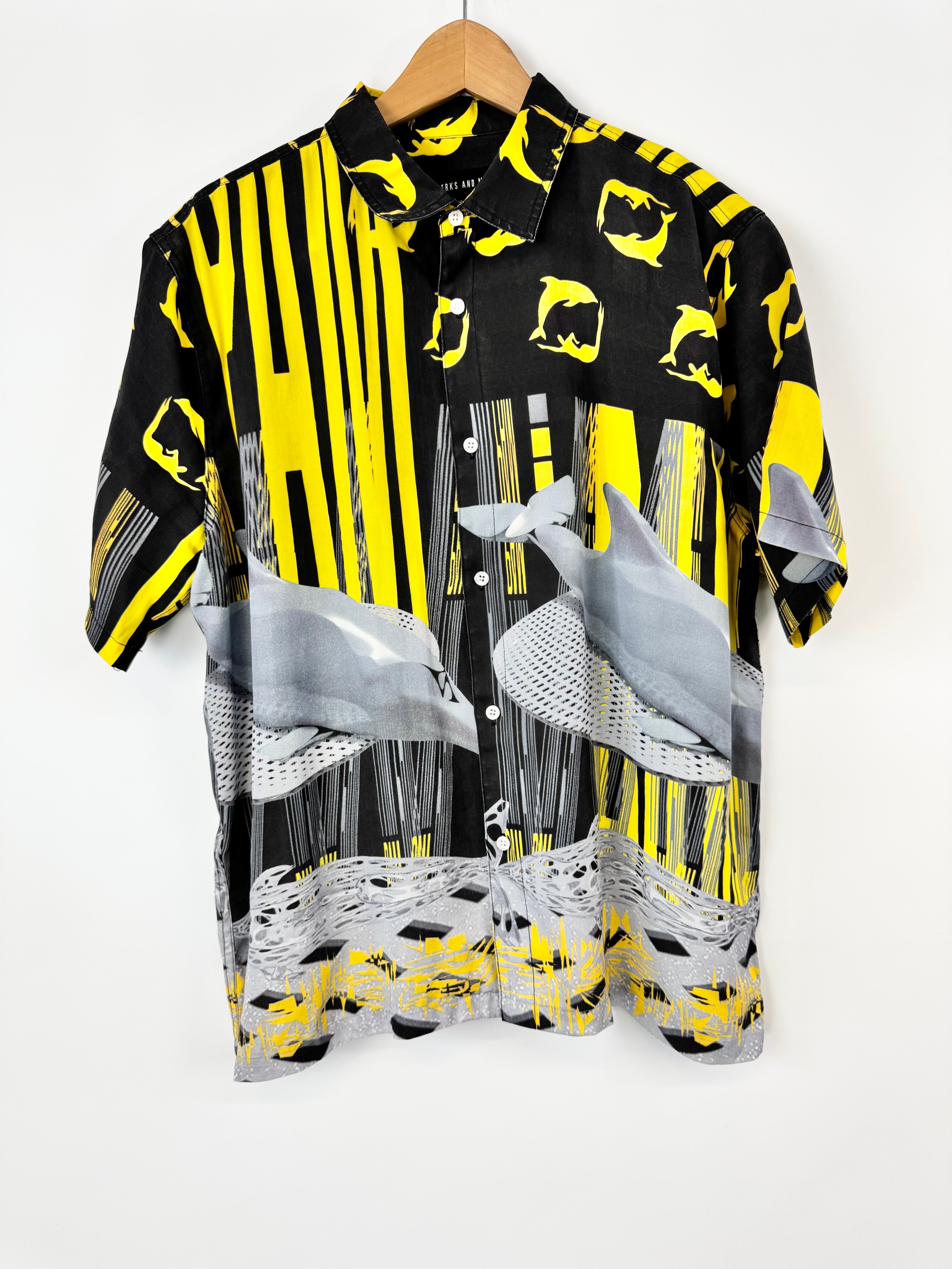 Black shirt with yellow and gray abstract patterns on a white background