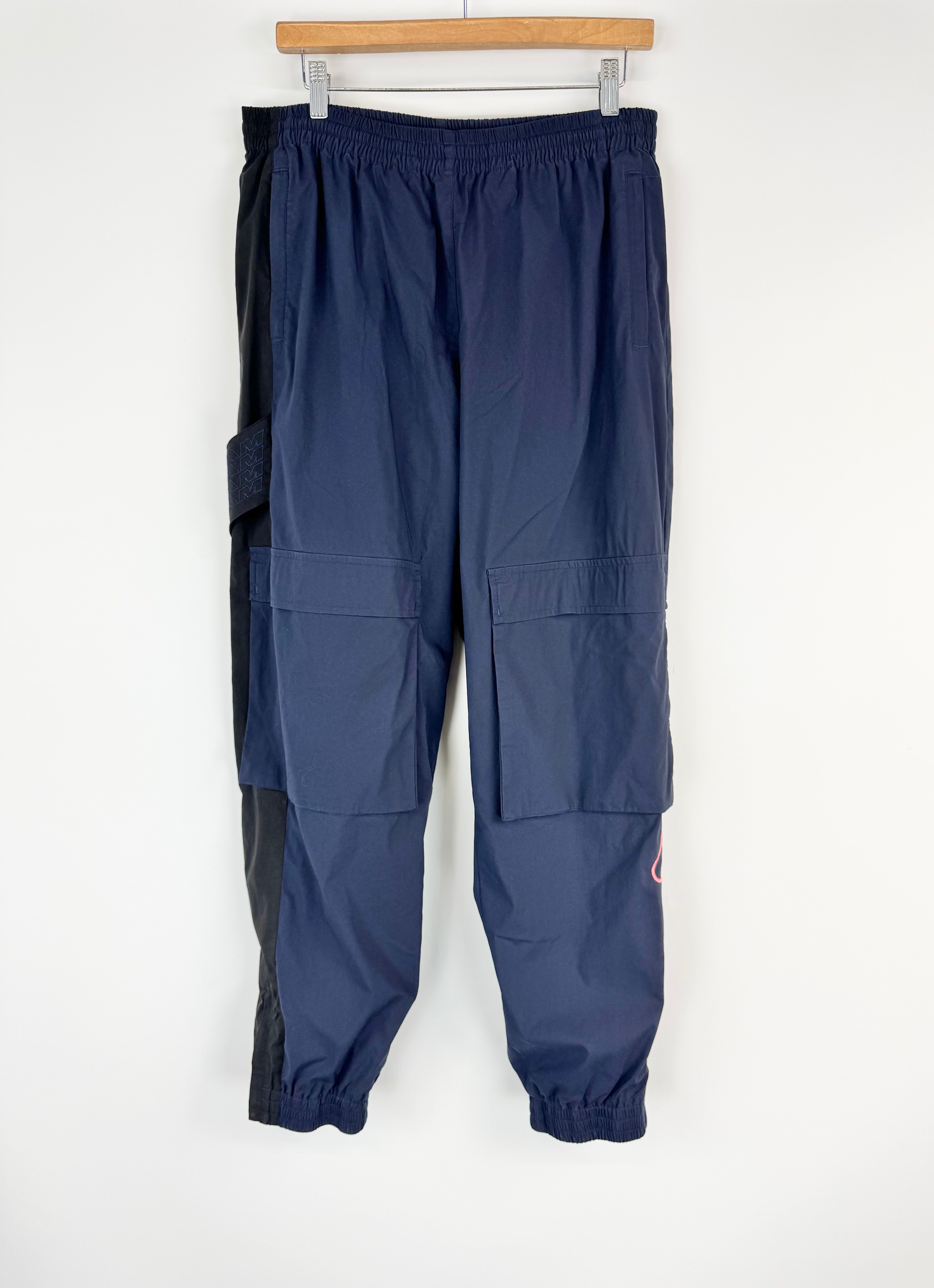 Navy blue pants with zippers on a white background