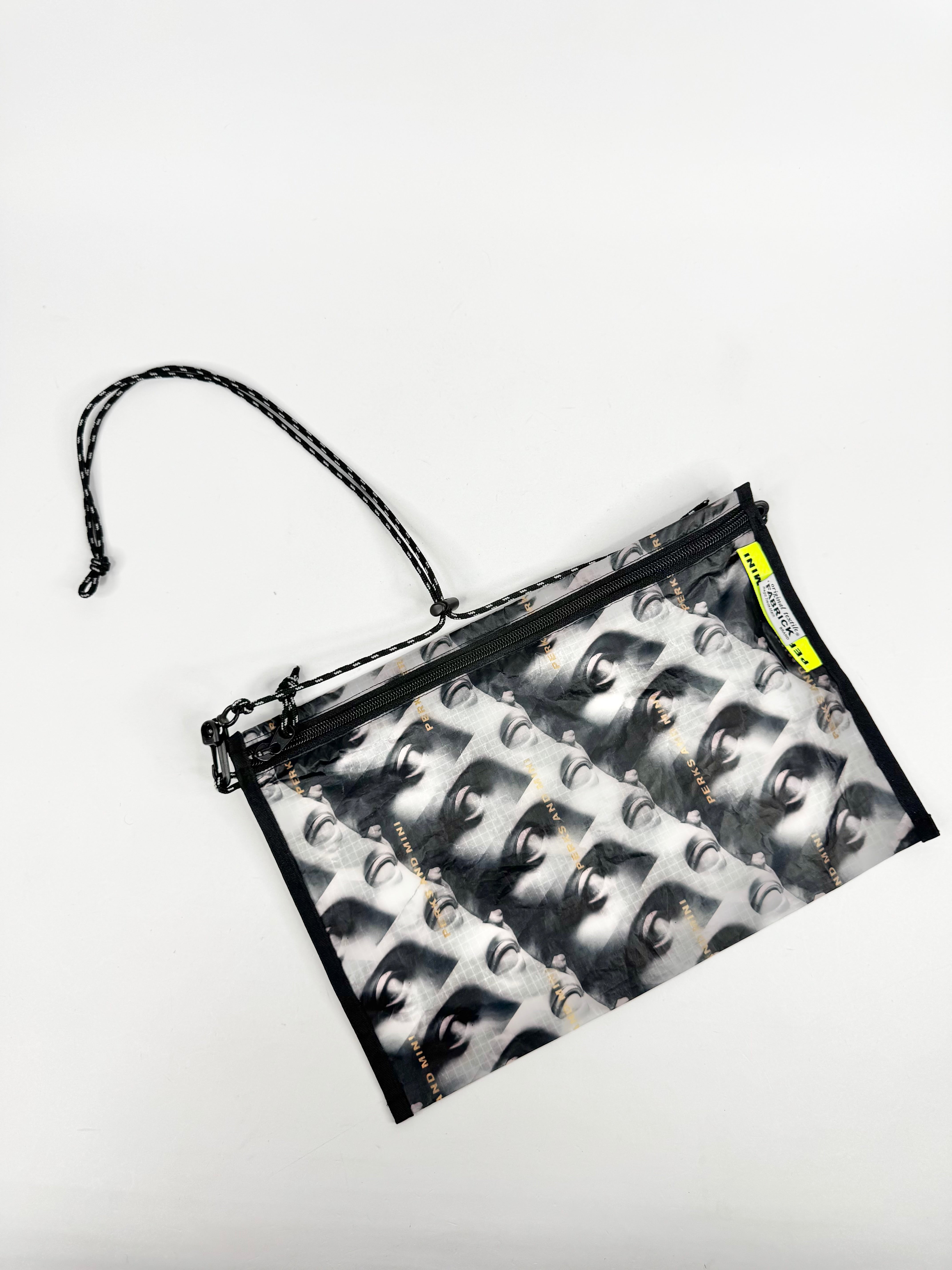 Clear pouch with black zipper and printed design on a white background