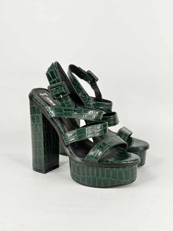 Green platform sandals with crocodile pattern on a white background