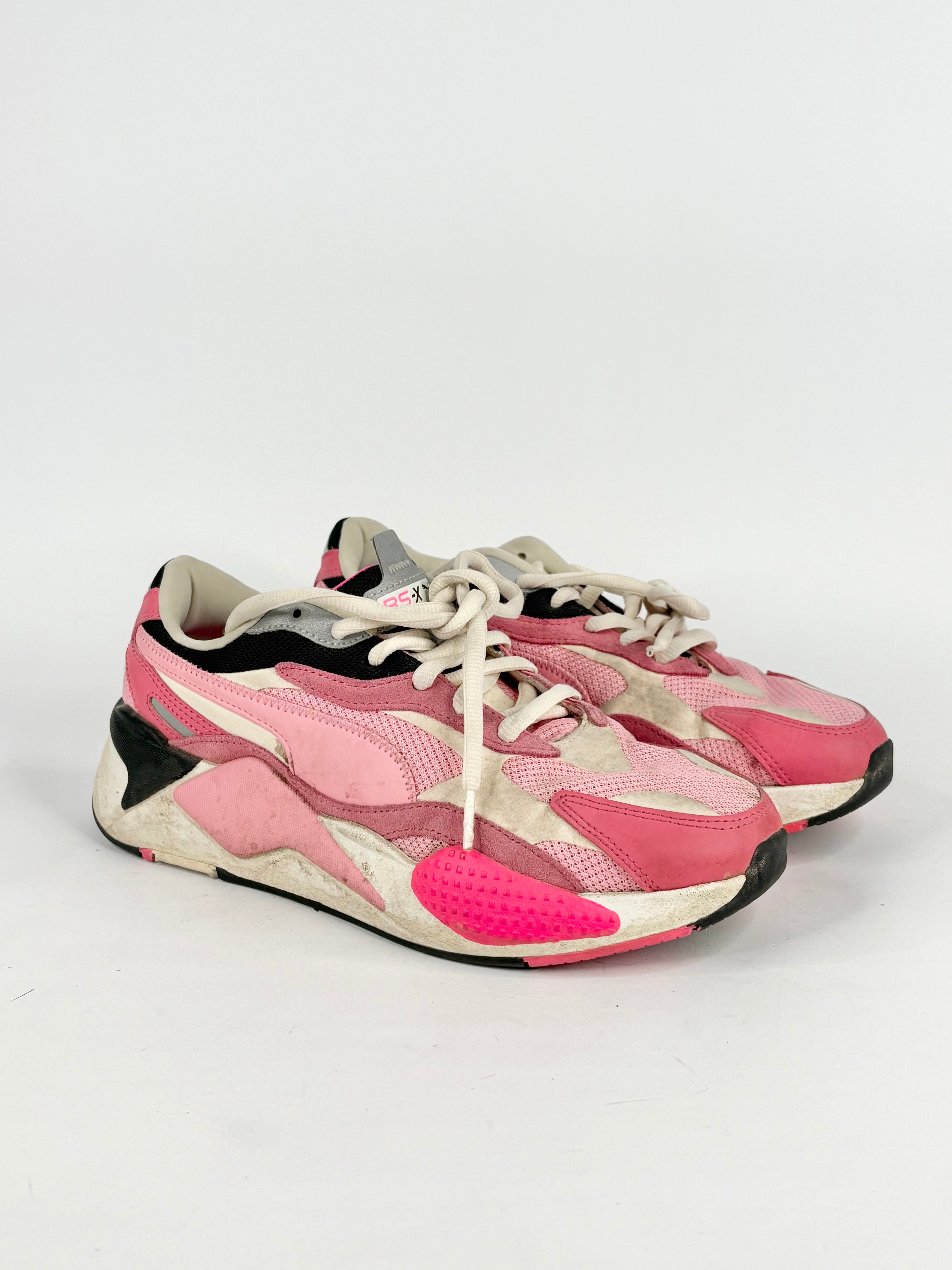 Pink and white sneakers on a light gray background