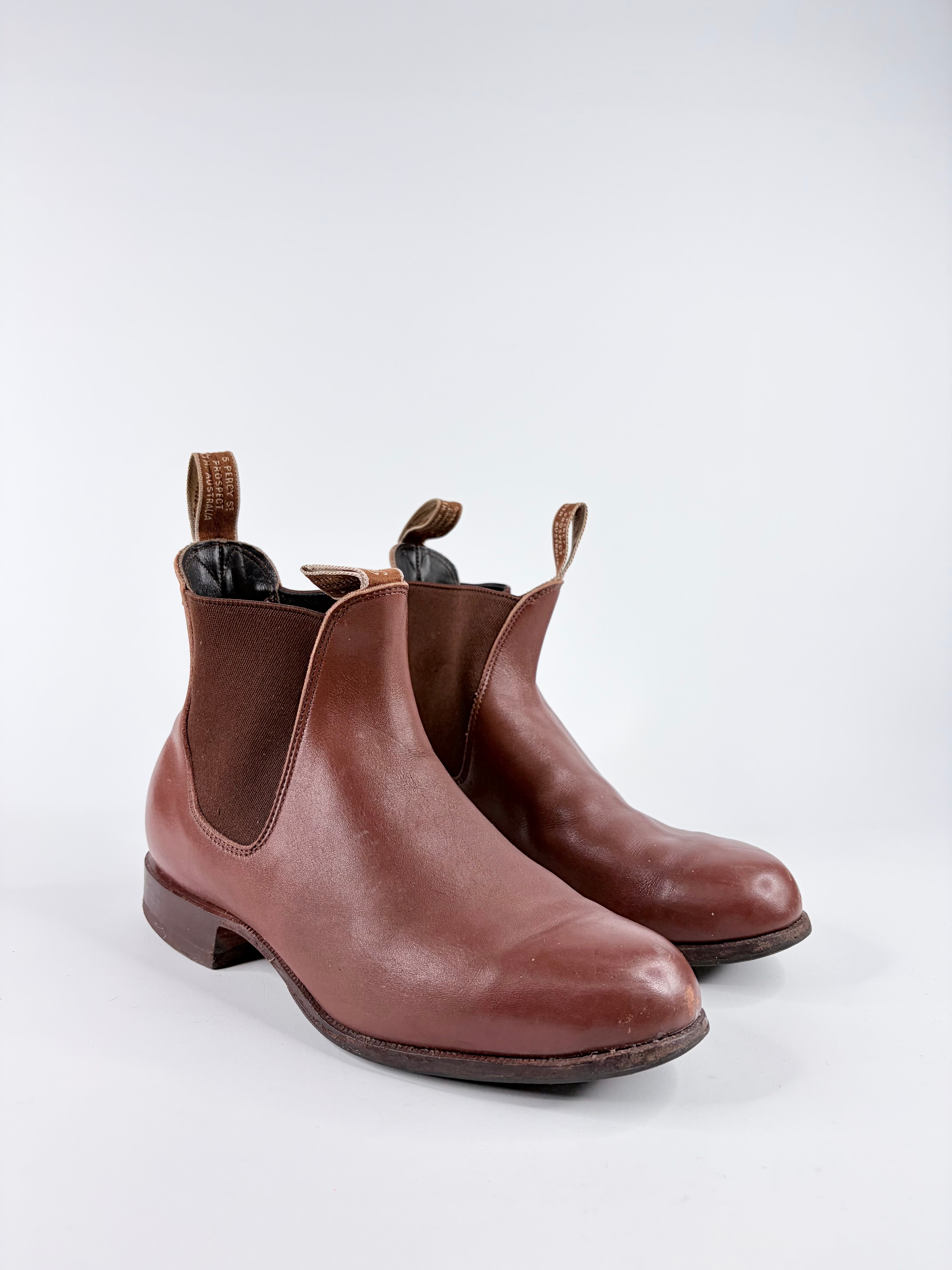 Pair of brown leather Chelsea boots on a white background