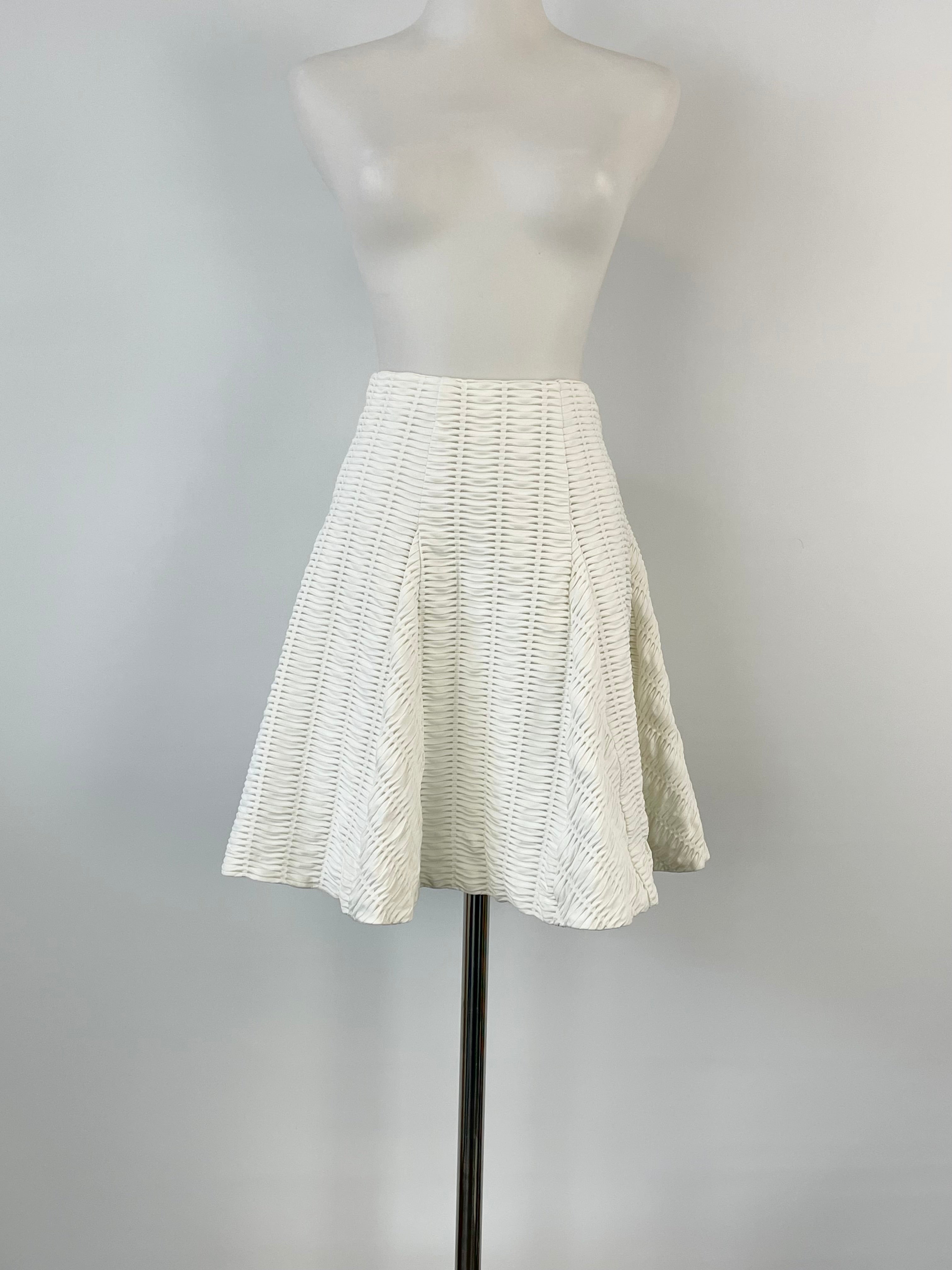 A midi skirt on a mannequin displaying an ivory wave-textured design.