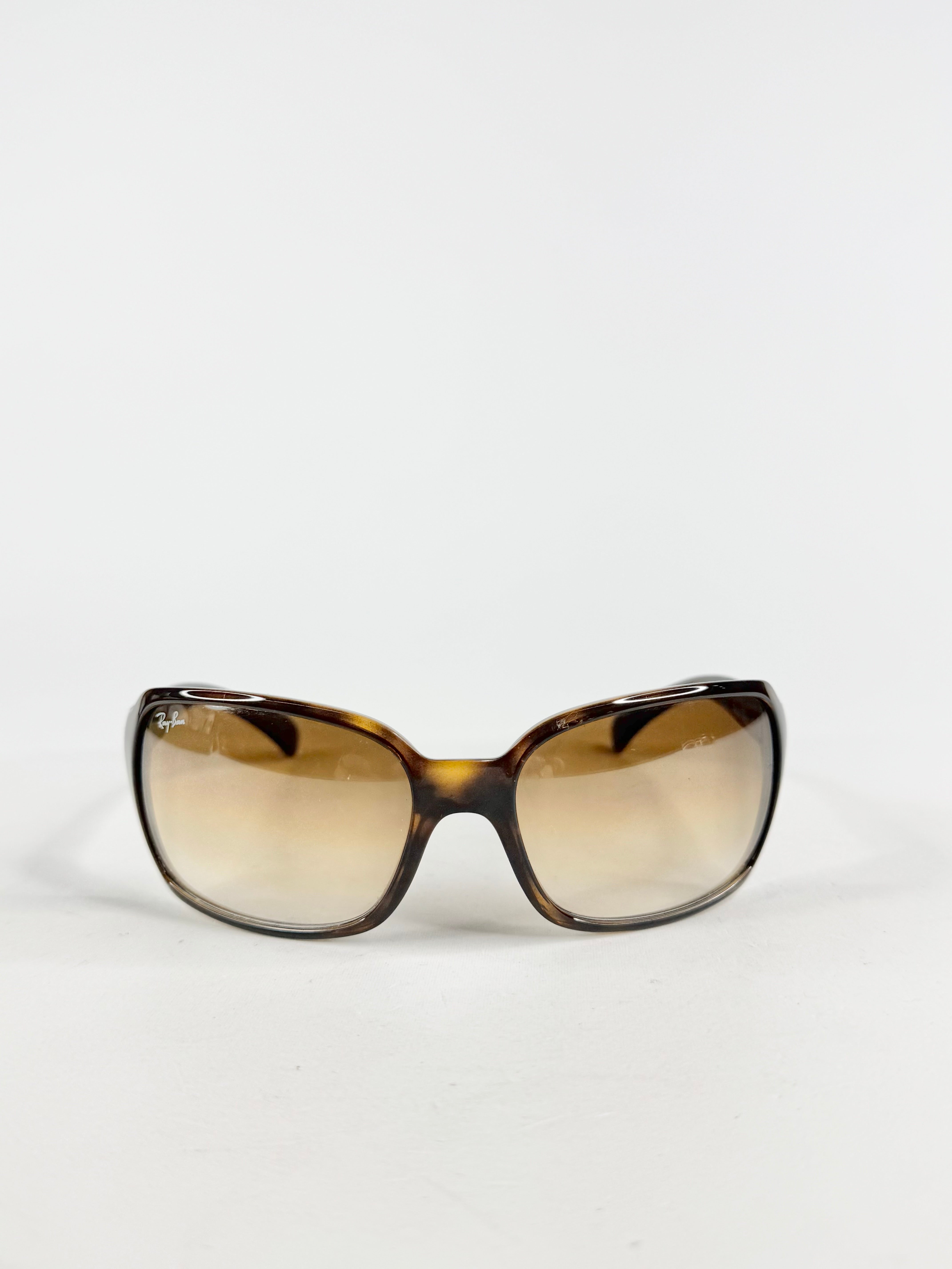 Sunglasses with brown gradient lenses on a white background