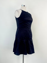 A Reiss black 'Marelle' textured pleated midi dress on a mannequin. The dress is sleeveless with a round neckline and falls to mid-calf in length.