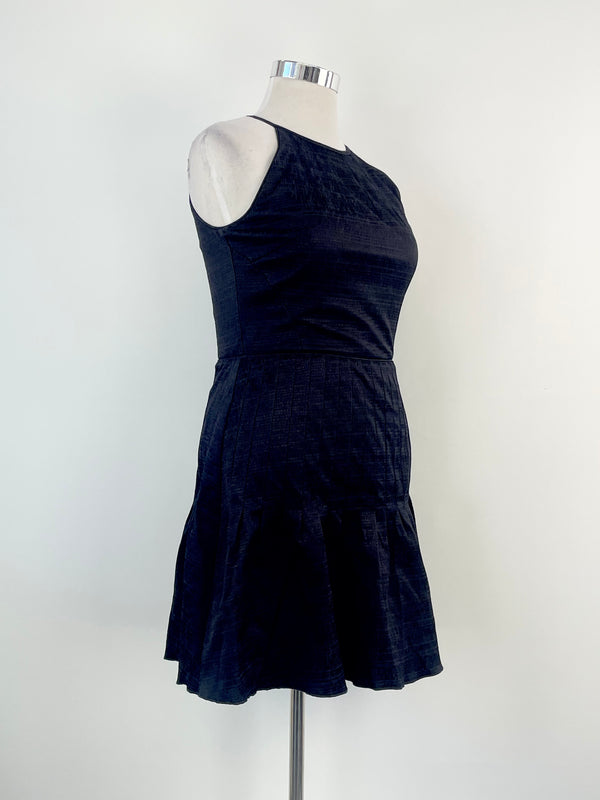 A Reiss black 'Marelle' textured pleated midi dress on a mannequin. The dress is sleeveless with a round neckline and falls to mid-calf in length.