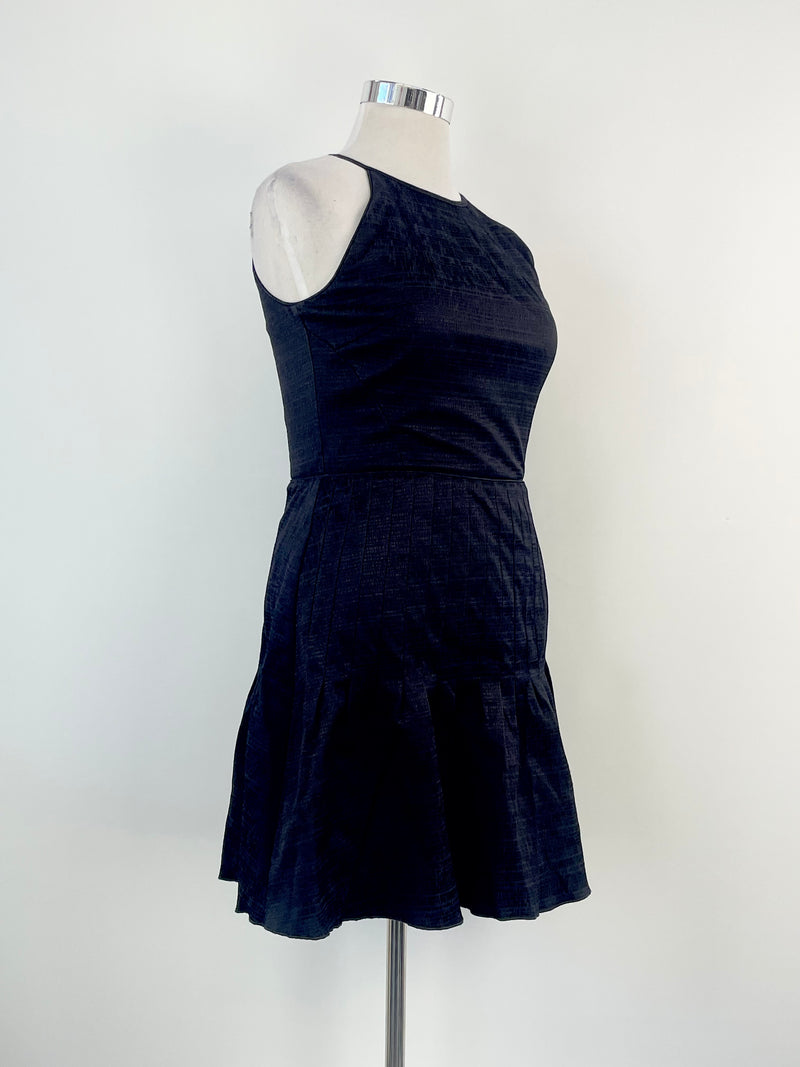 A Reiss black 'Marelle' textured pleated midi dress on a mannequin. The dress is sleeveless with a round neckline and falls to mid-calf in length.