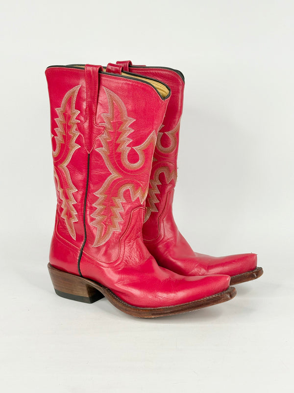 Pair of red cowboy boots with gold embroidery on a white background