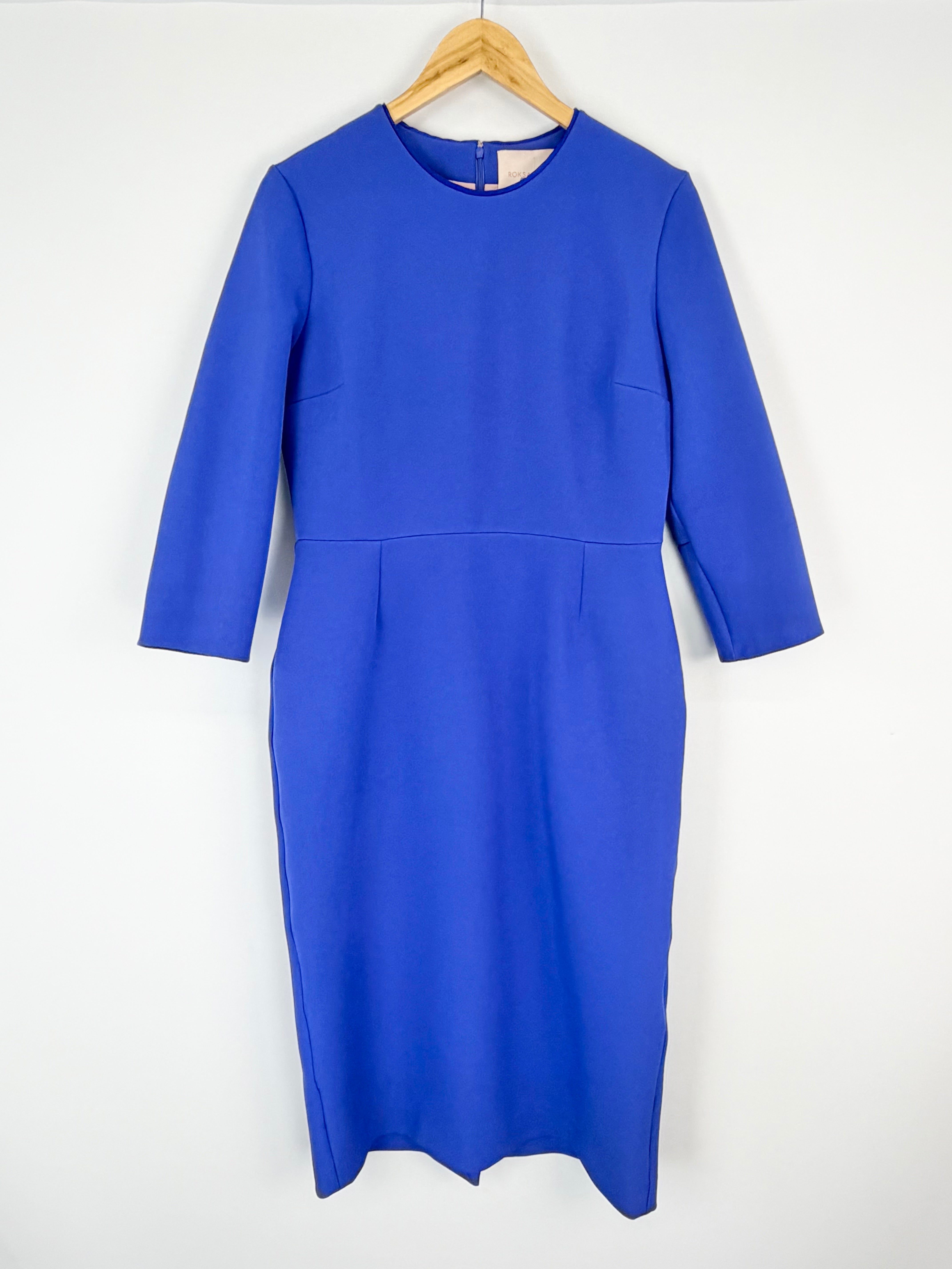 Blue dress on a hanger against a white background