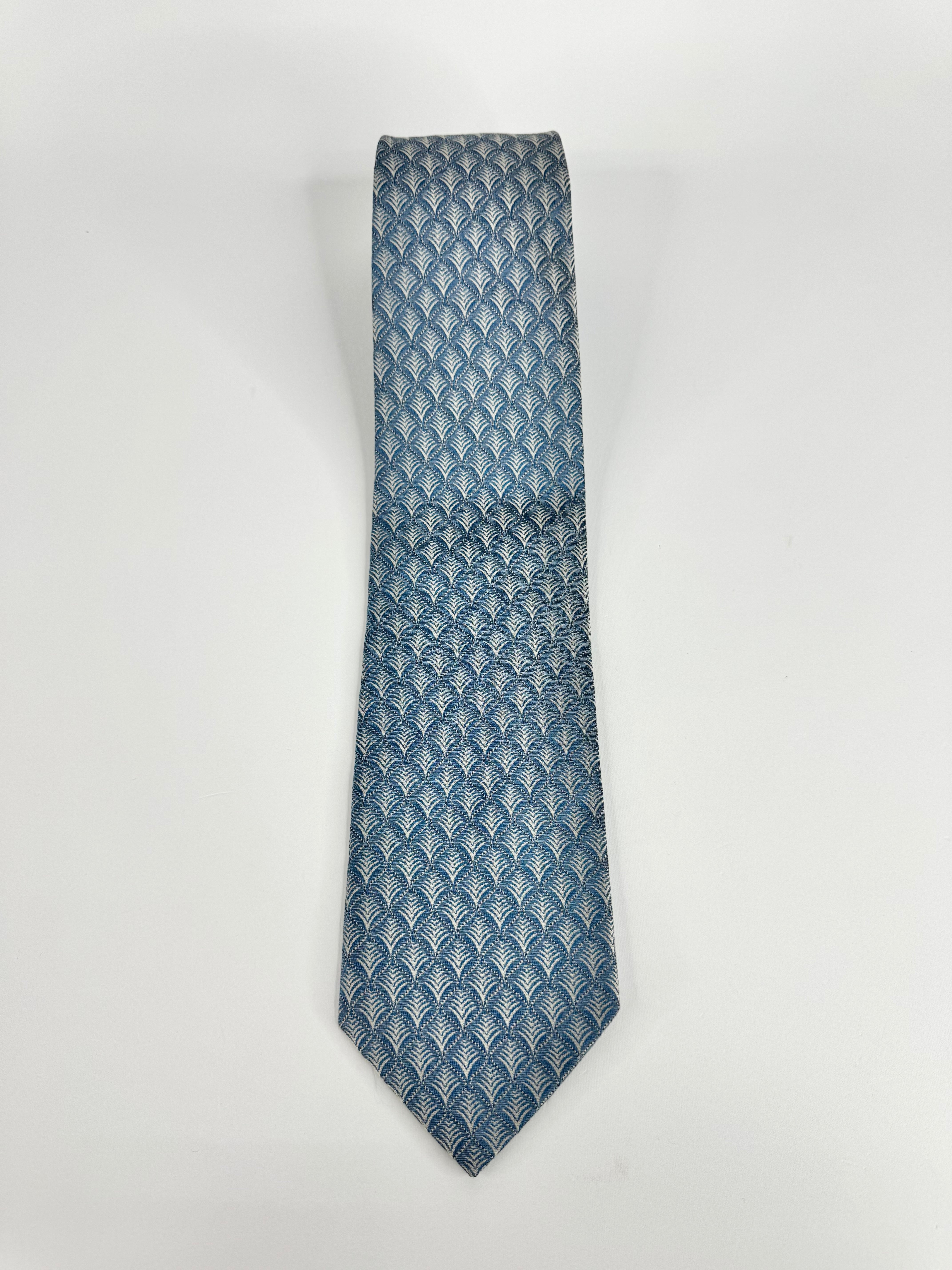 Blue patterned tie on a white background