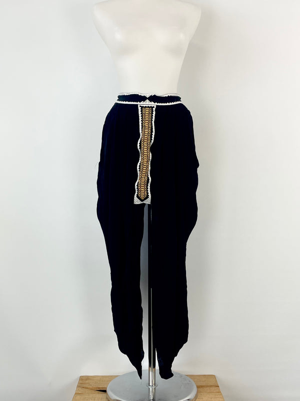 Sass & Bide black sheer embellished skirt with white trims and gold paneling, displayed on a mannequin.