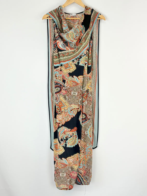 Long, patterned dress draped over a hanger on a white background