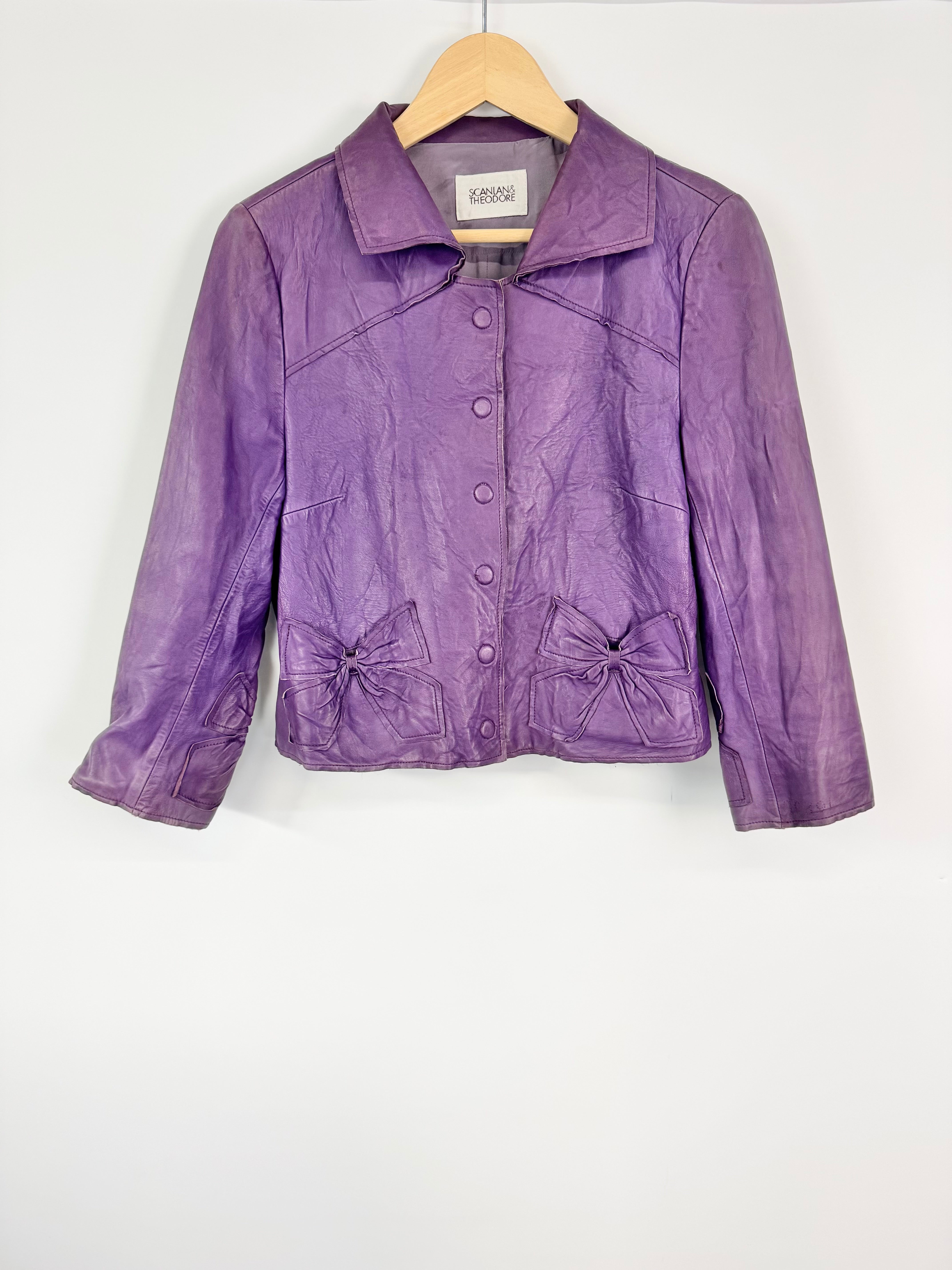 Purple leather jacket on a hanger against a white background