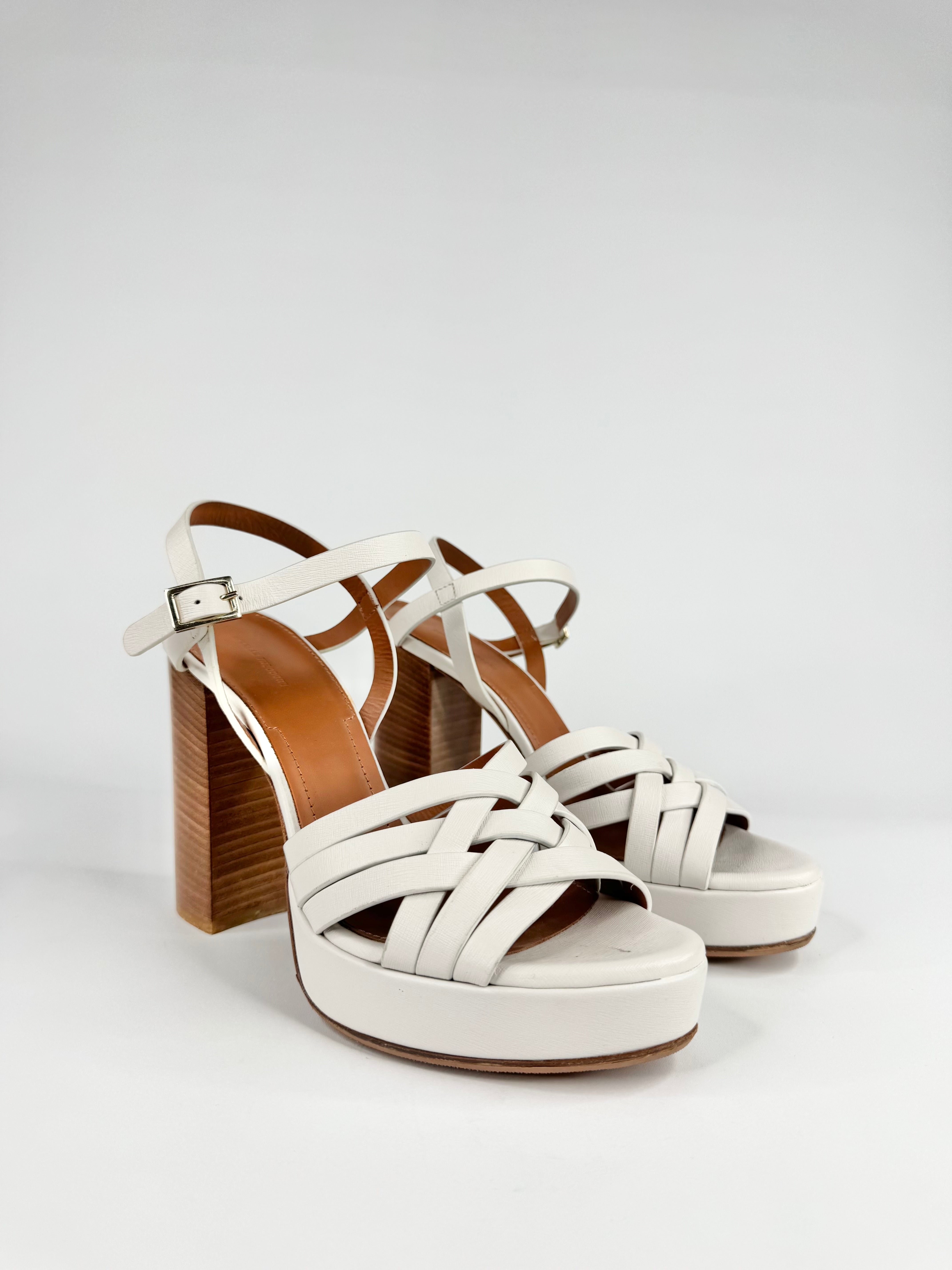 White platform sandals with wooden heel on a light gray background