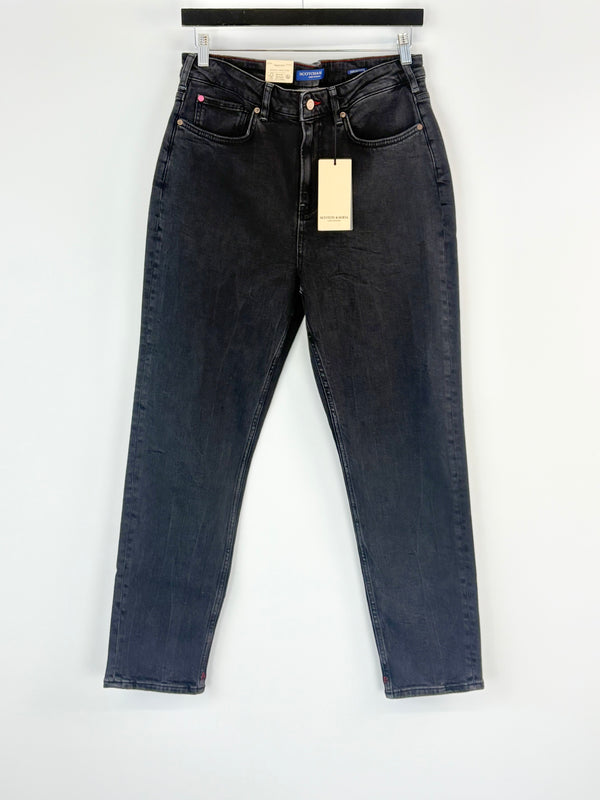 Charcoal  jeans with a tag on a white background