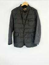 Charcoal jacket on a hanger against a white background
