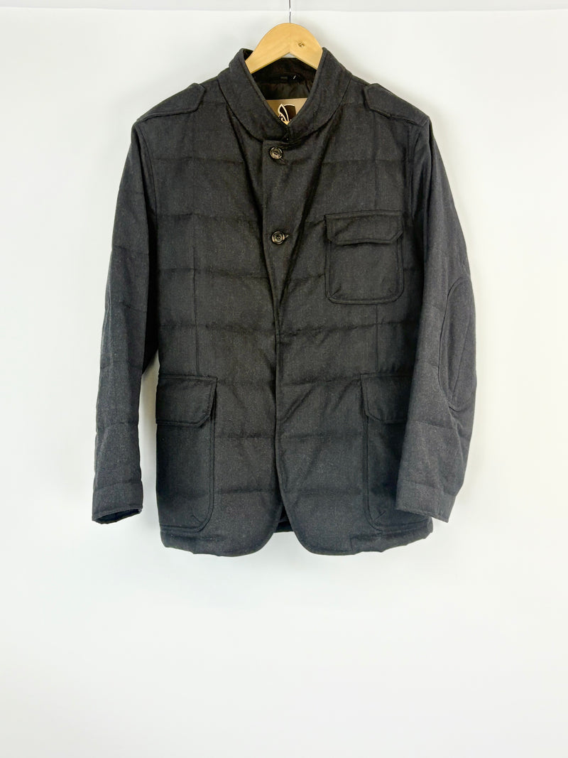 Charcoal jacket on a hanger against a white background
