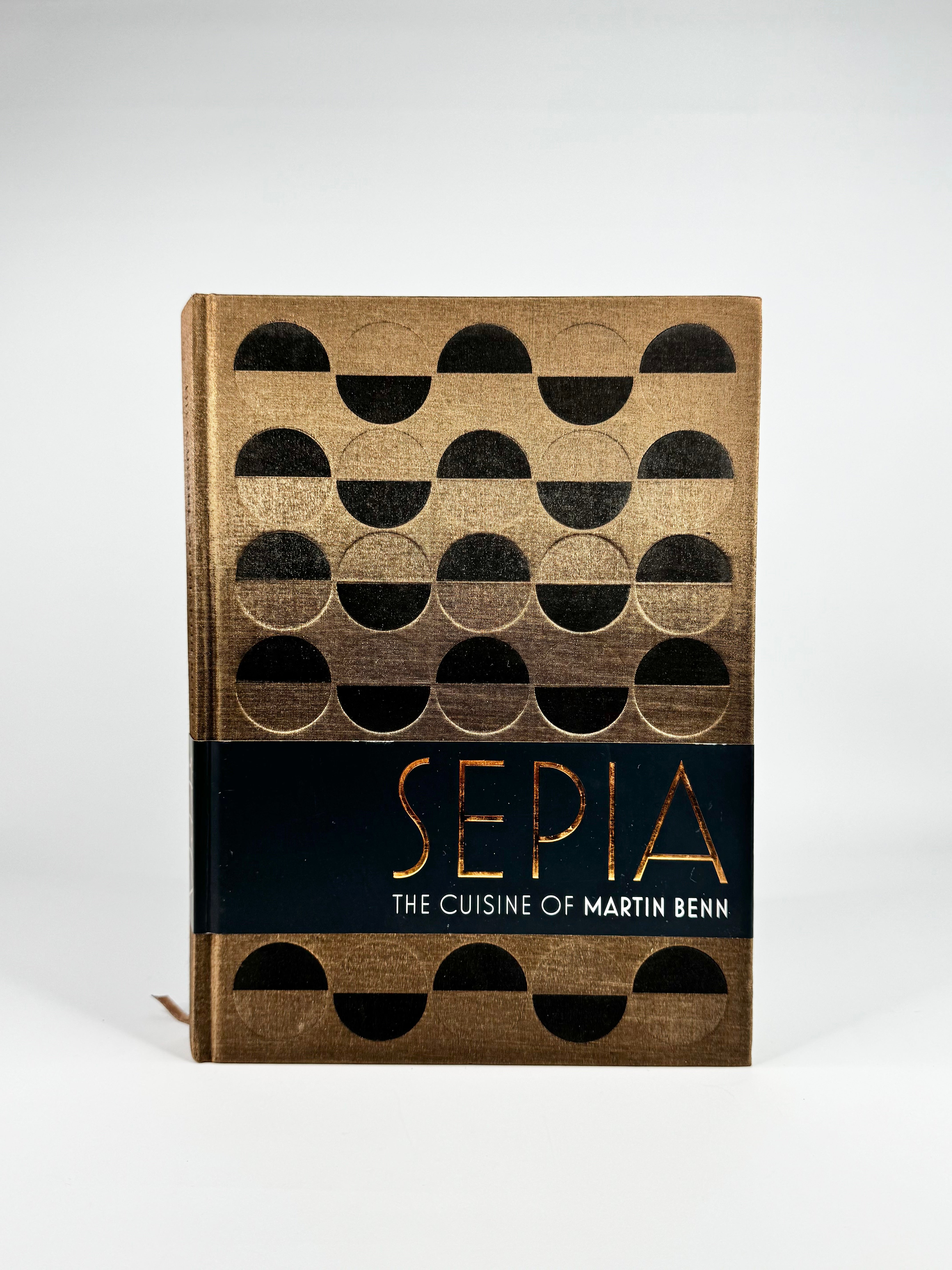 Book titled 'Sepia: The Cuisine of Martin Benn' with geometric pattern on cover