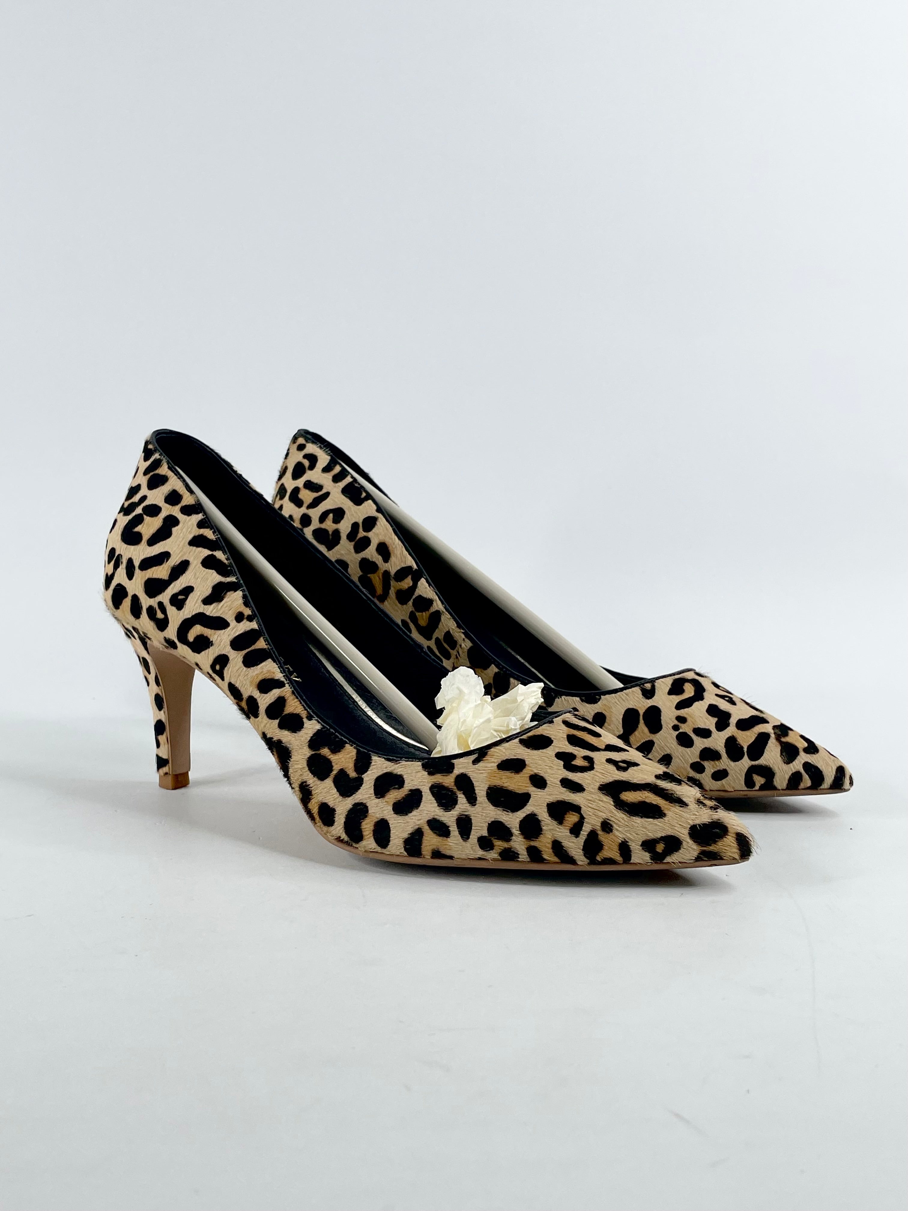A pair of leopard print cowfur pumps by Shoes of Prey, with visible heel and closure detail.