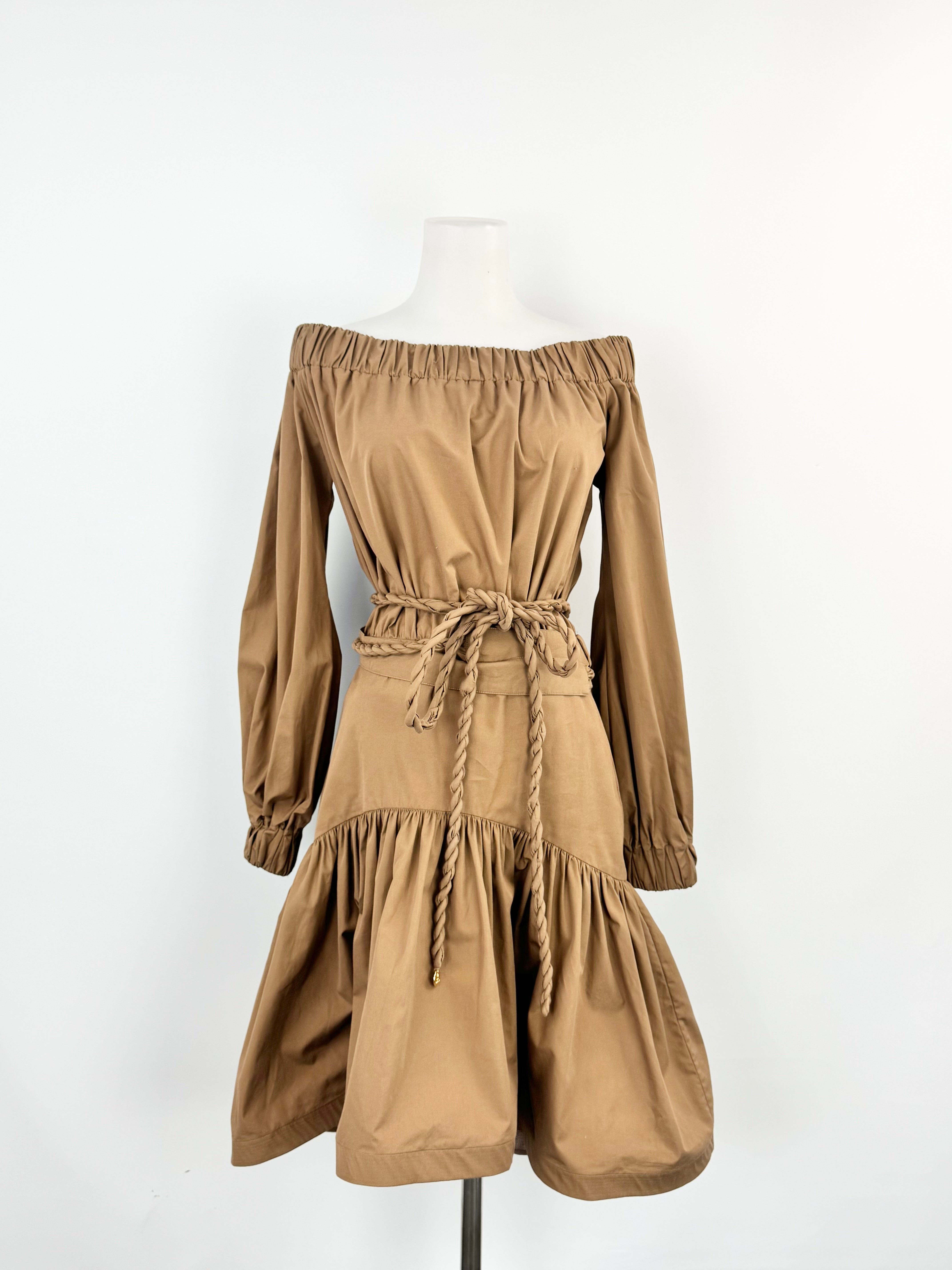 Brown off-shoulder dress on a mannequin against a white background