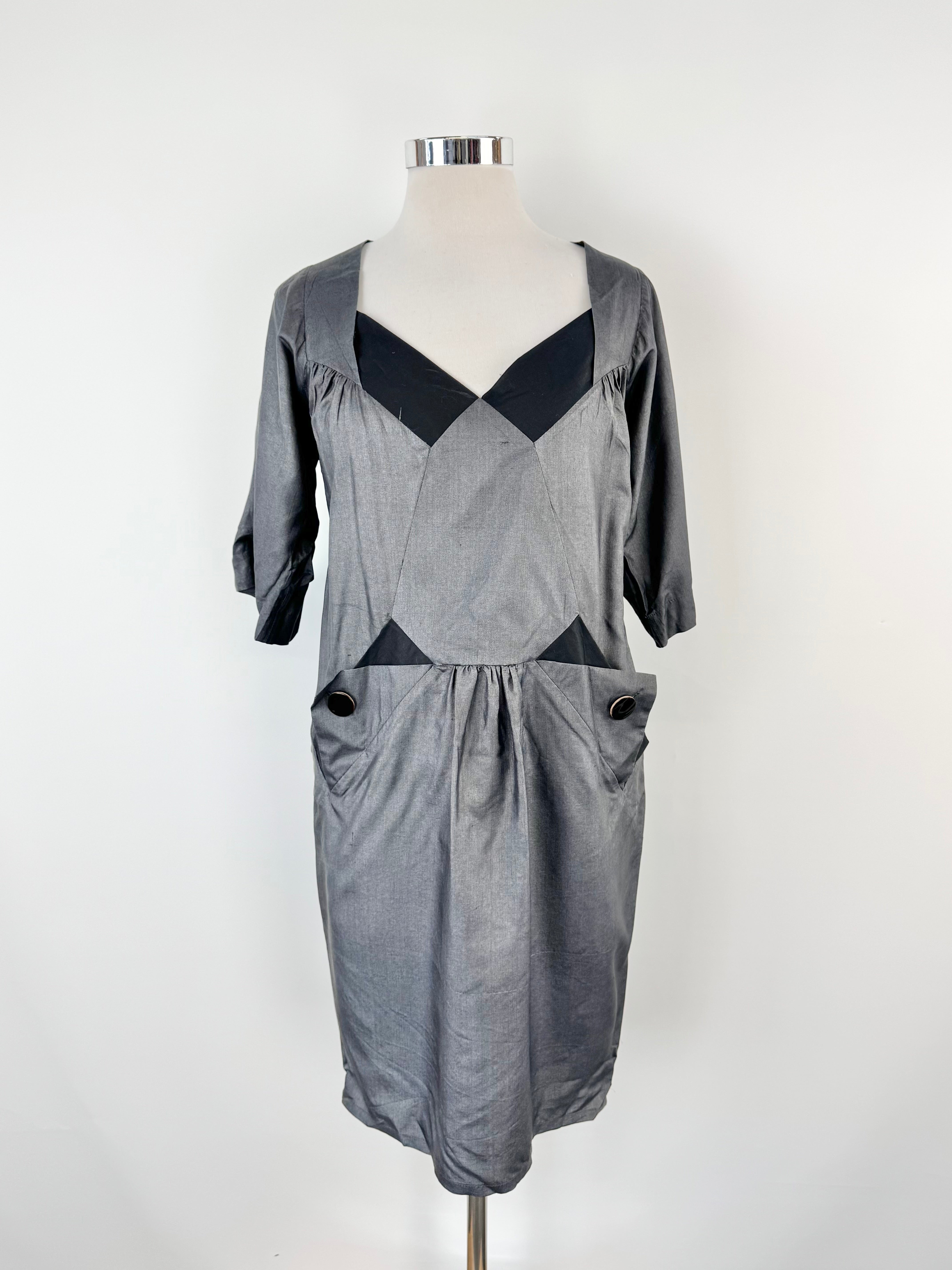 Grey dress on a mannequin against a white background