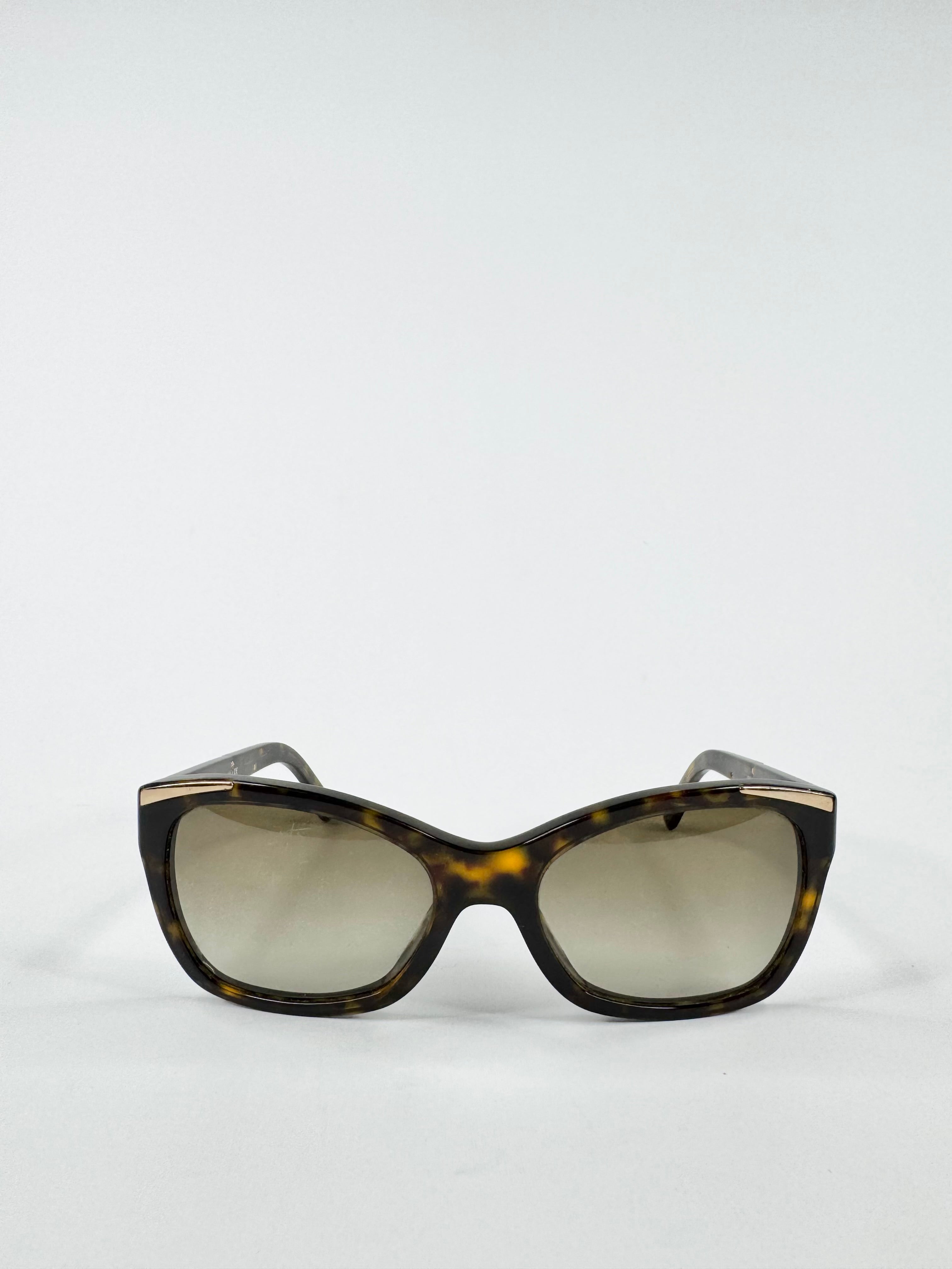 Sunglasses with tortoiseshell frame and reflective lenses on a white background