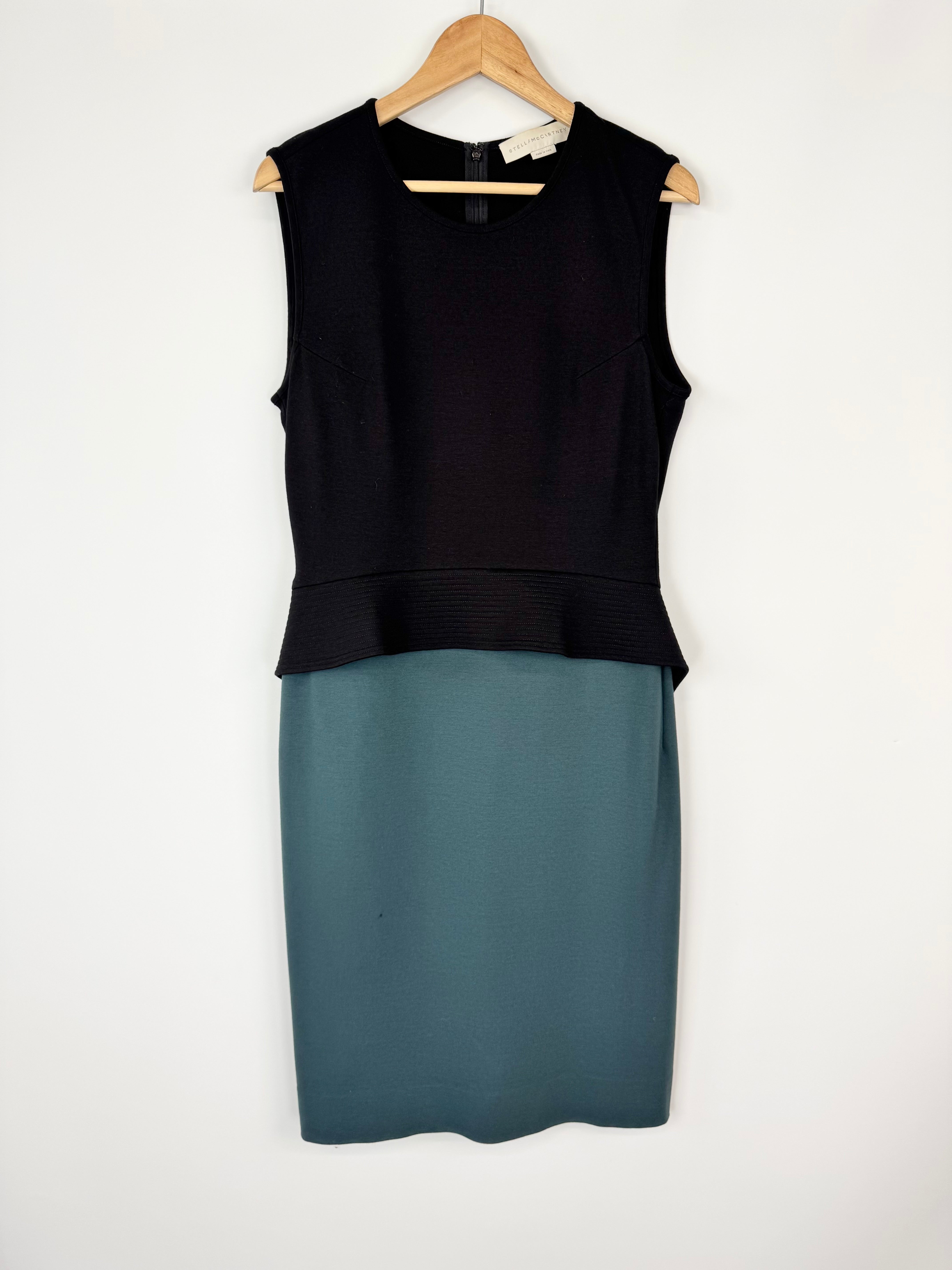Black sleeveless top and teal skirt set on a white background
