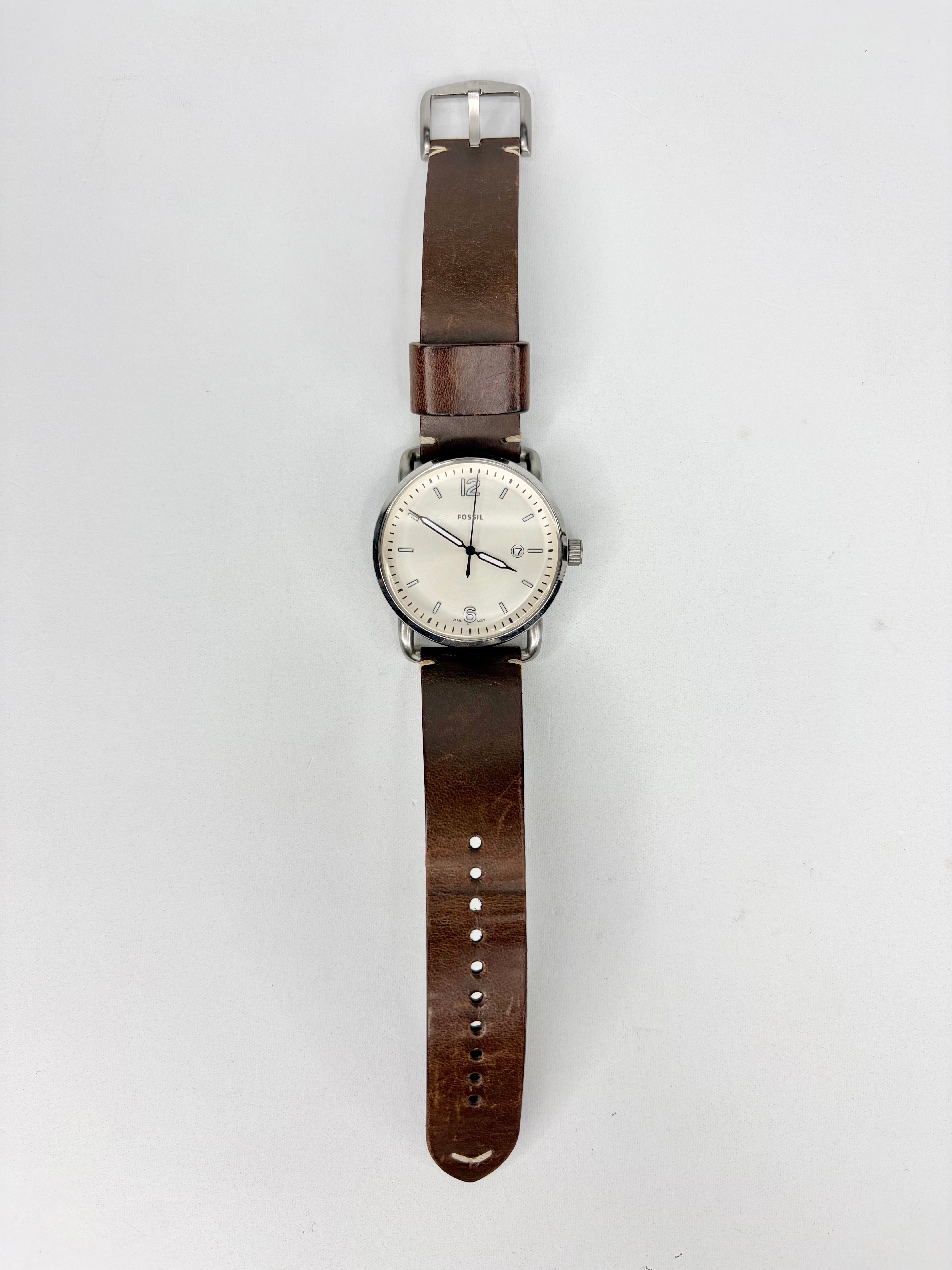 Wristwatch with brown leather strap on a white background