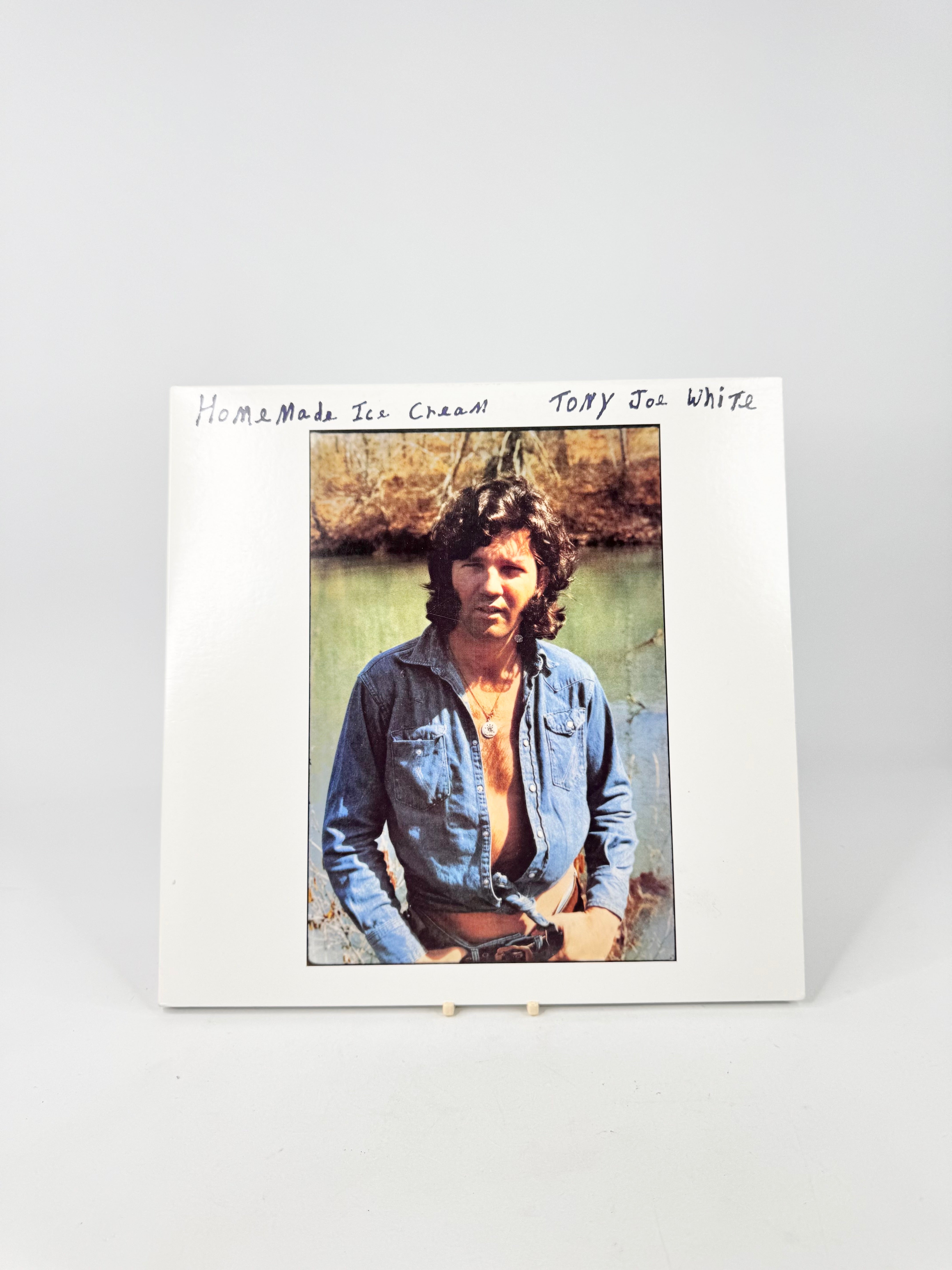Album cover with a person by a river and text 'Home Made Tin Can' by Tony Joe White