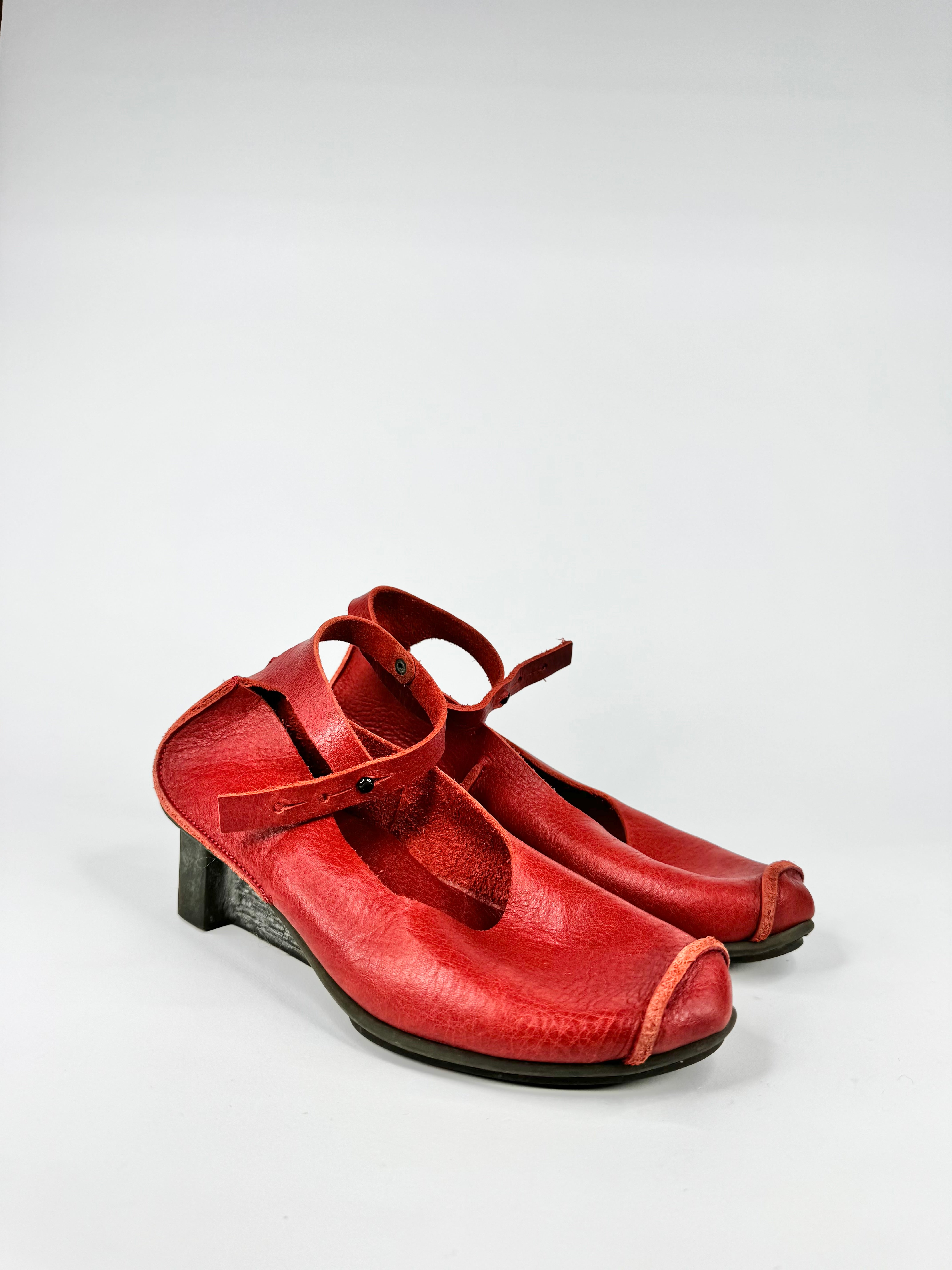 Pair of red leather shoes on a white background