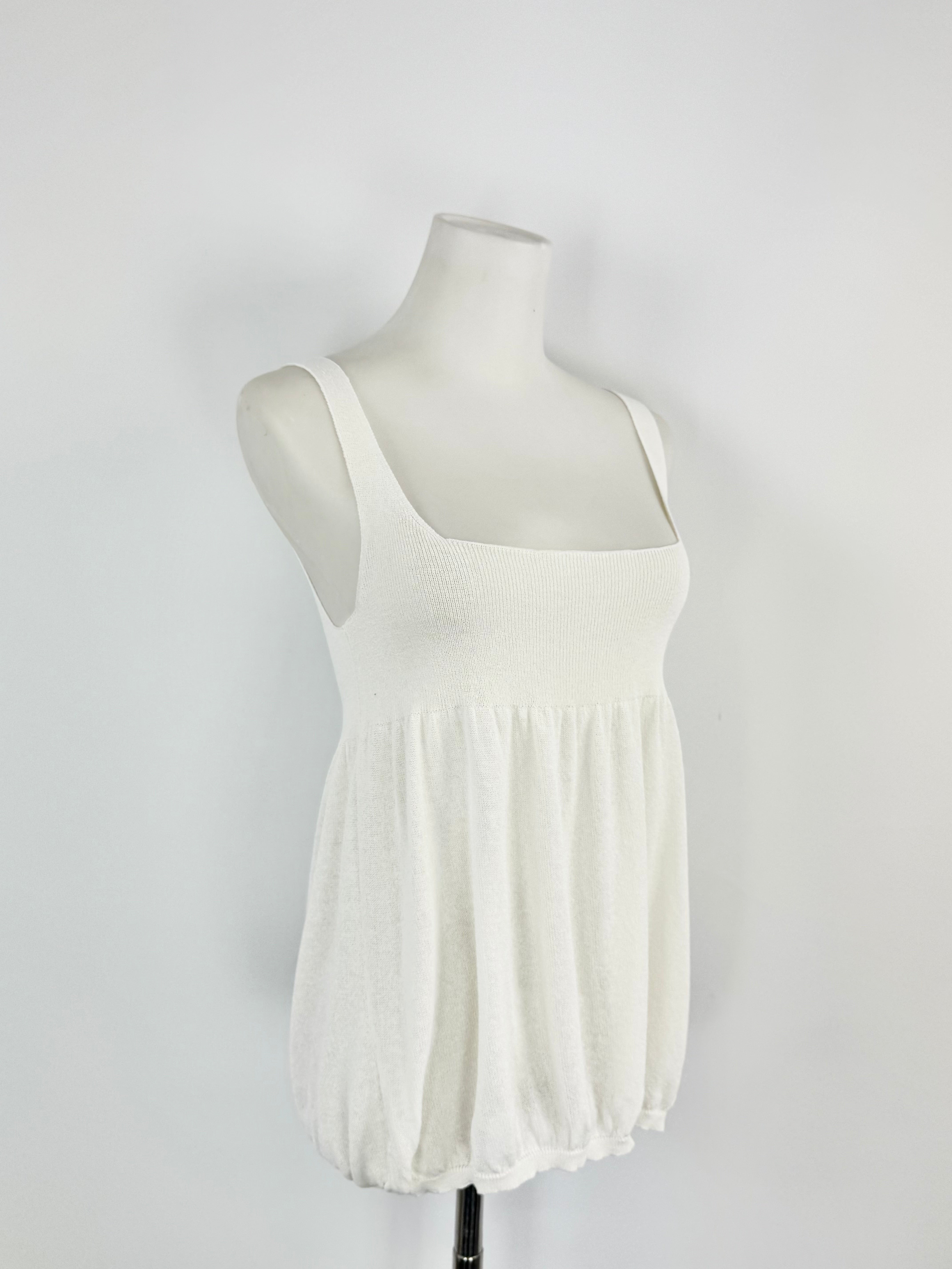 White sleeveless top on a mannequin against a white background