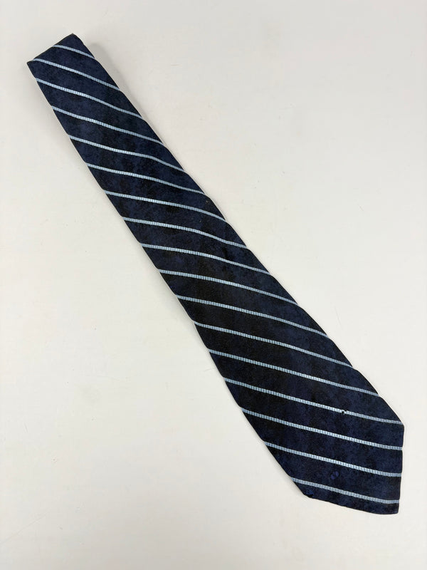 Navy blue tie with white stripes on a light gray background