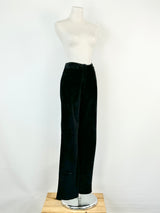 A pair of black suede slacks displayed on a mannequin against a white background, with the slacks appearing to fit a size AU8.