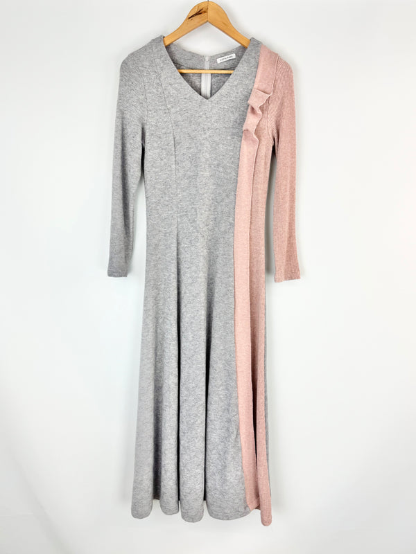 Gray dress with pink accents on a hanger against a white background