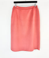 Pink skirt on a hanger against a white background