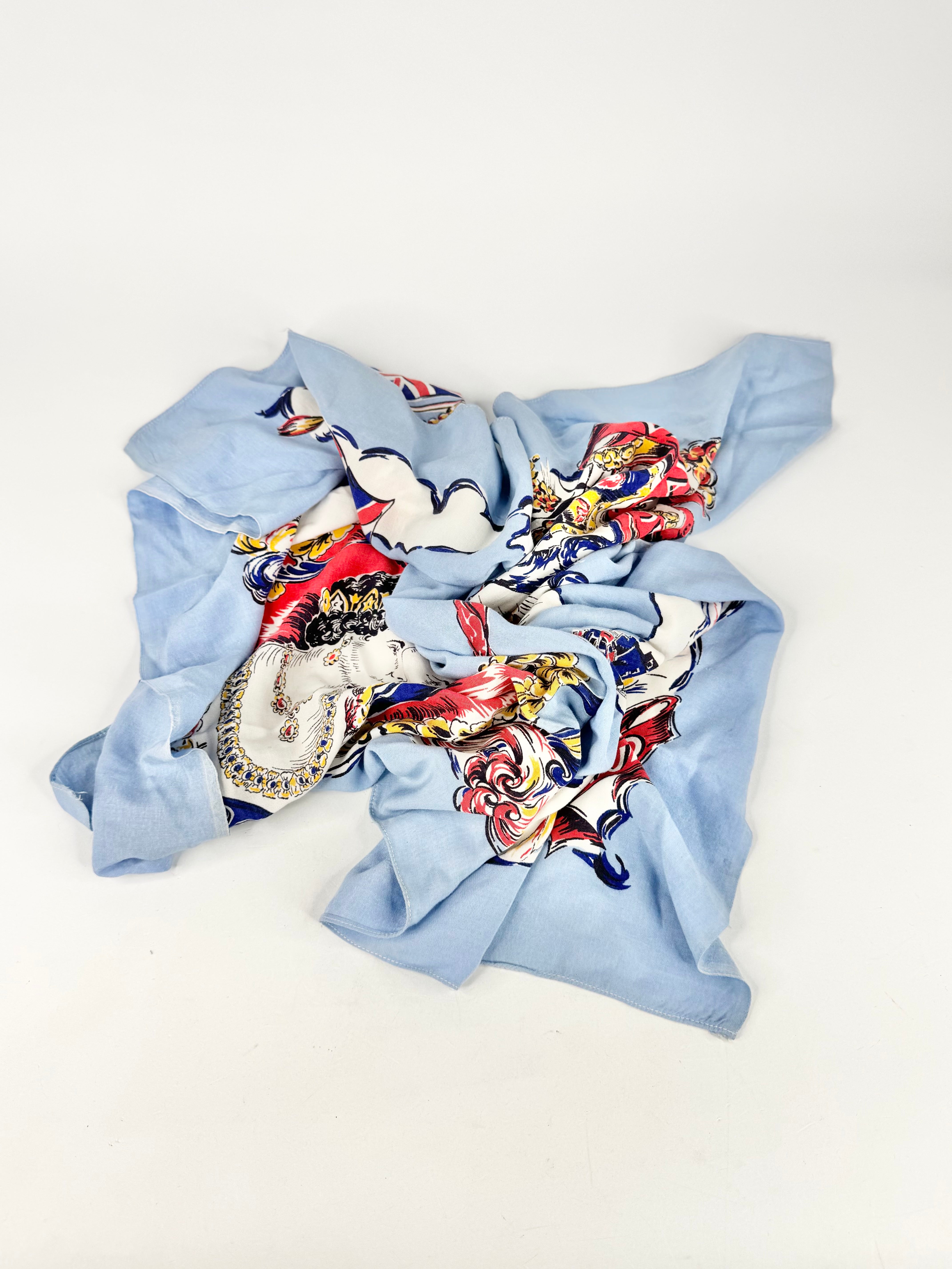 Light blue scarf with colorful pattern on a white background