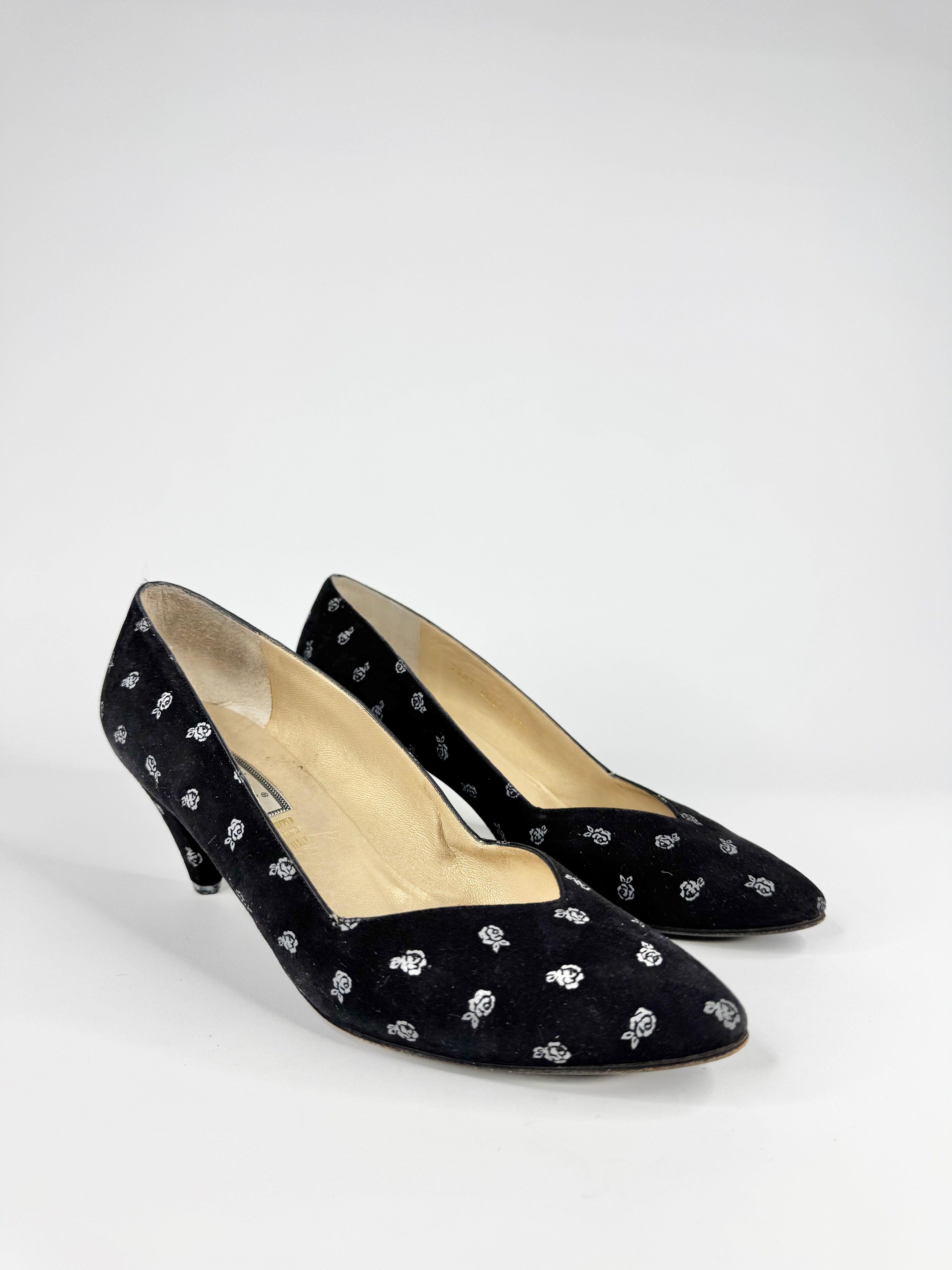 Black high-heeled shoes with white patterns on a white background