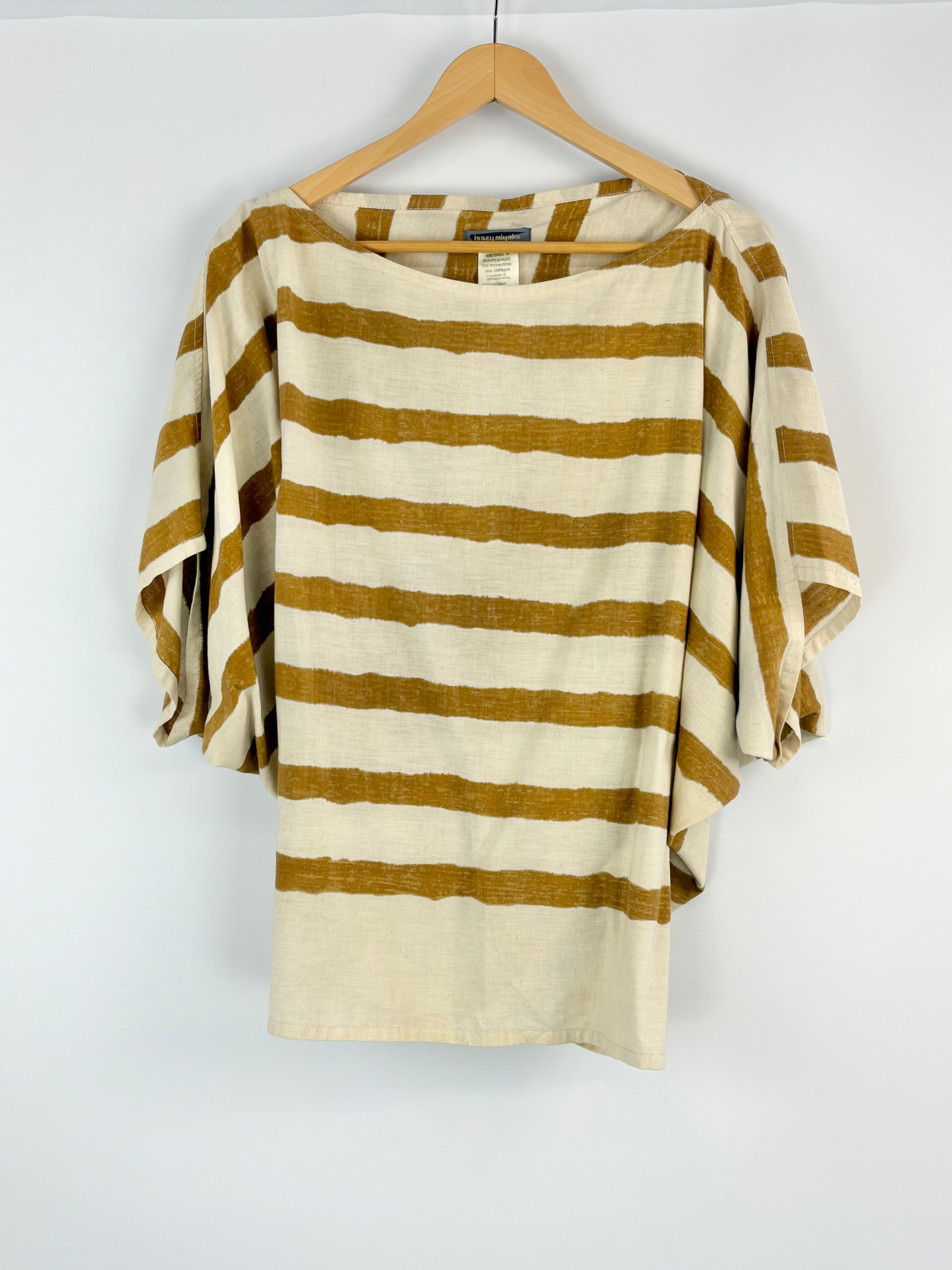 Striped sweater on a hanger against a white background