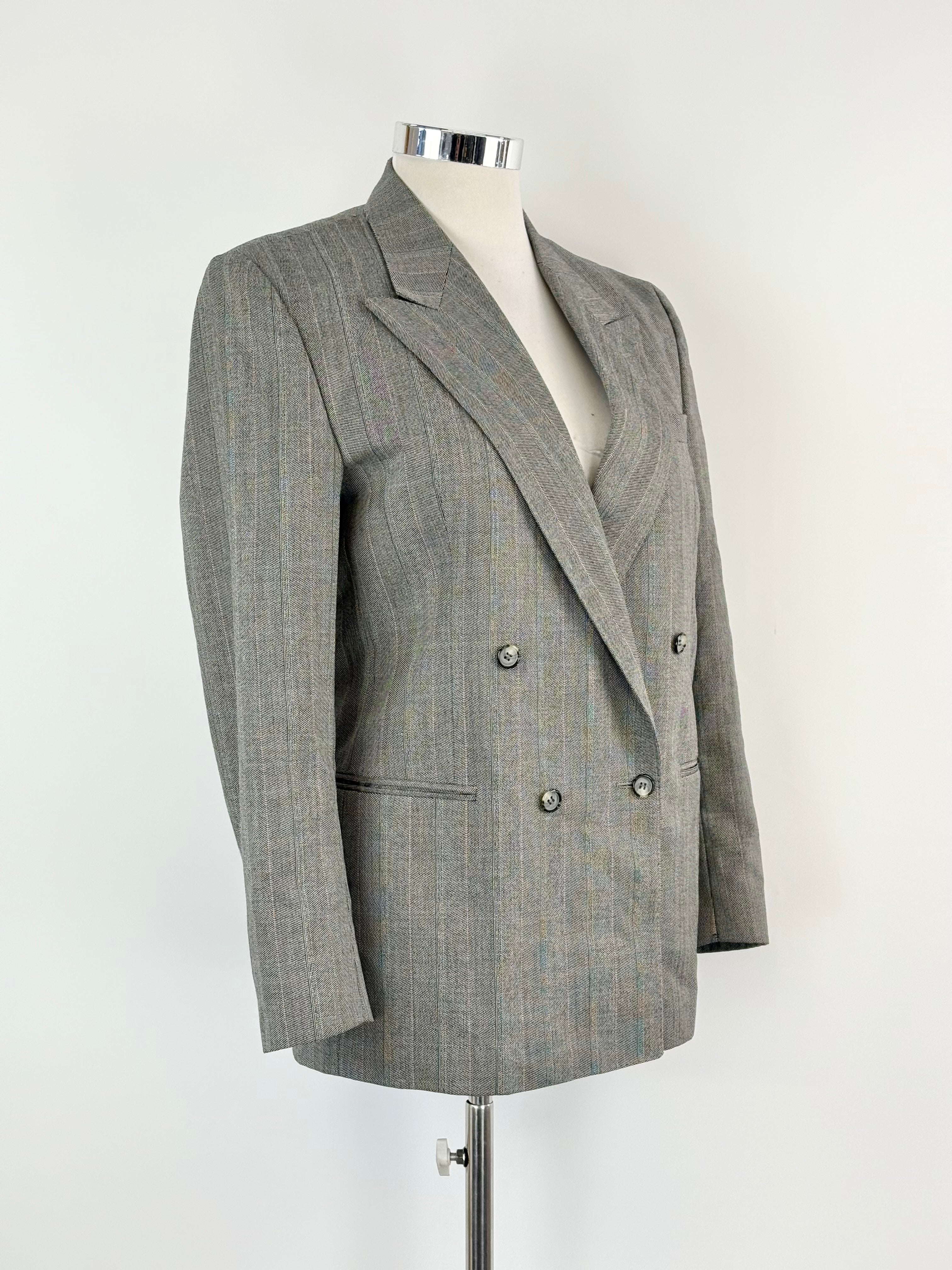 Gray checkered blazer on a mannequin against a white background