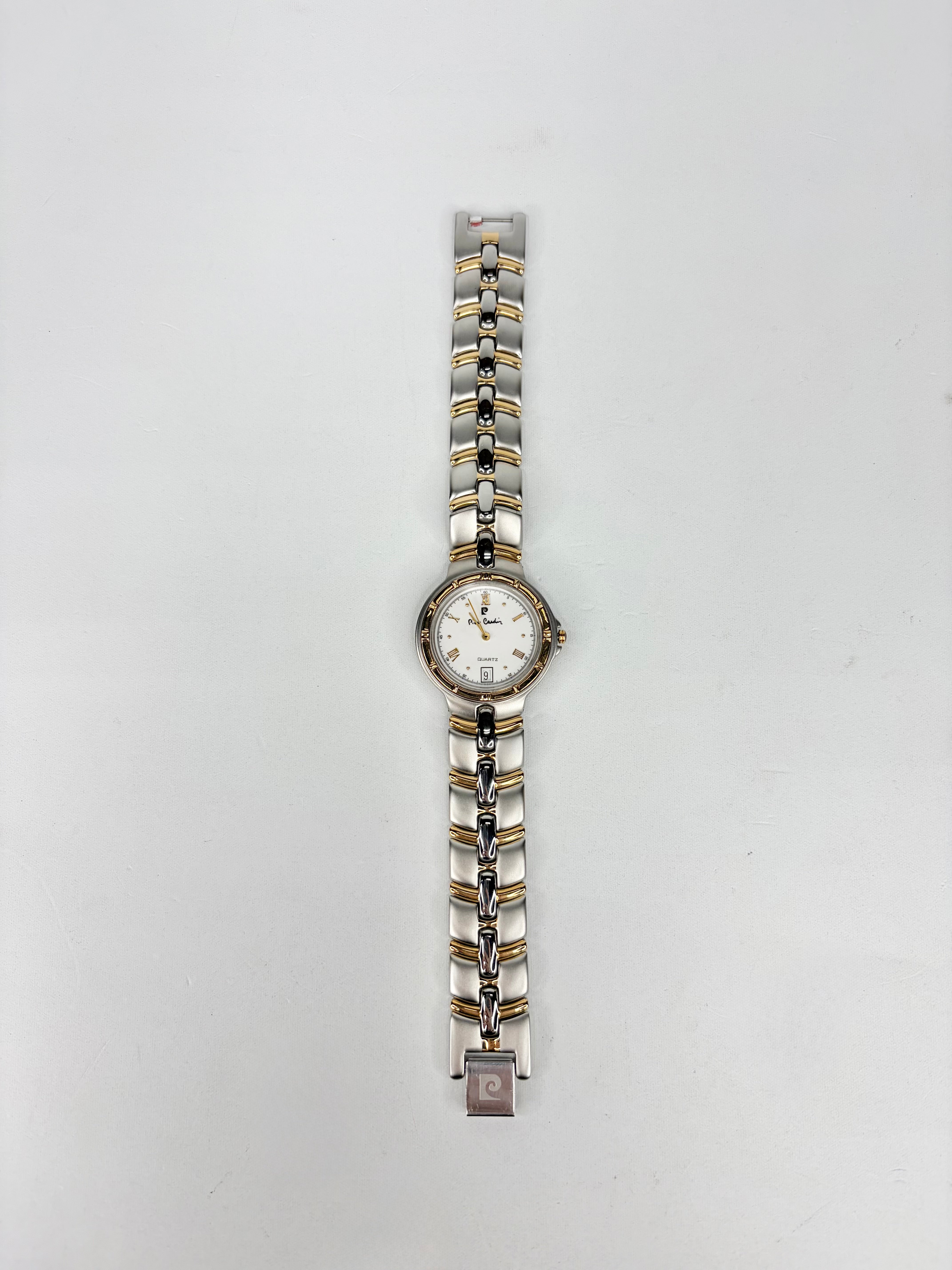 Wristwatch with a silver and gold band on a white background