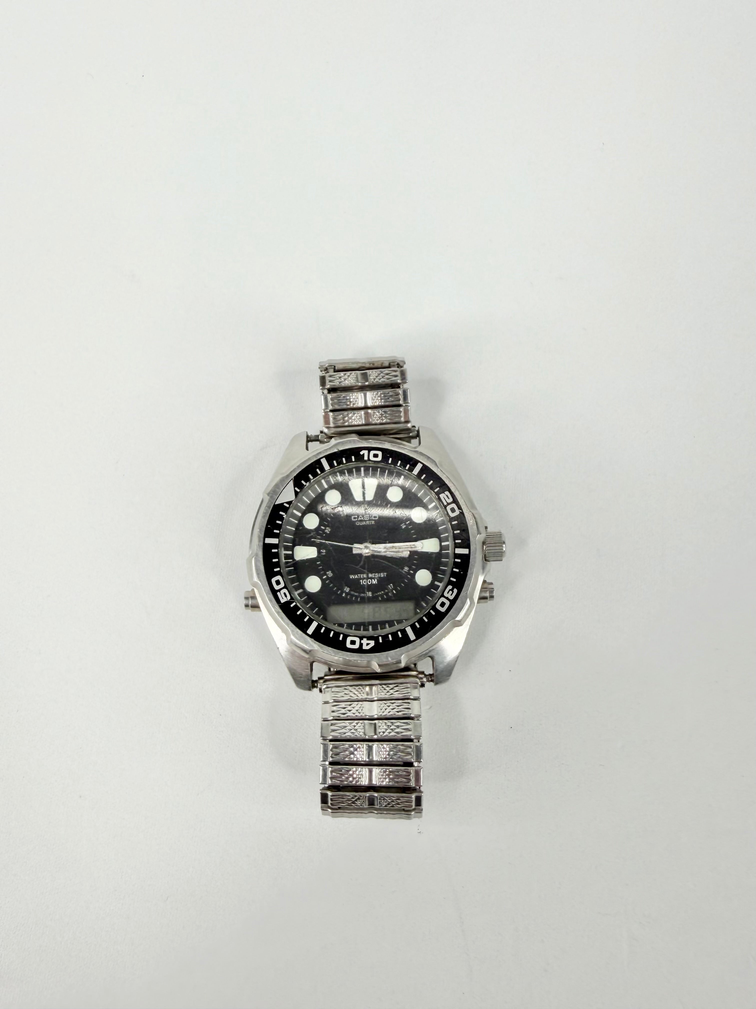 Silver wristwatch with a black face on a white background