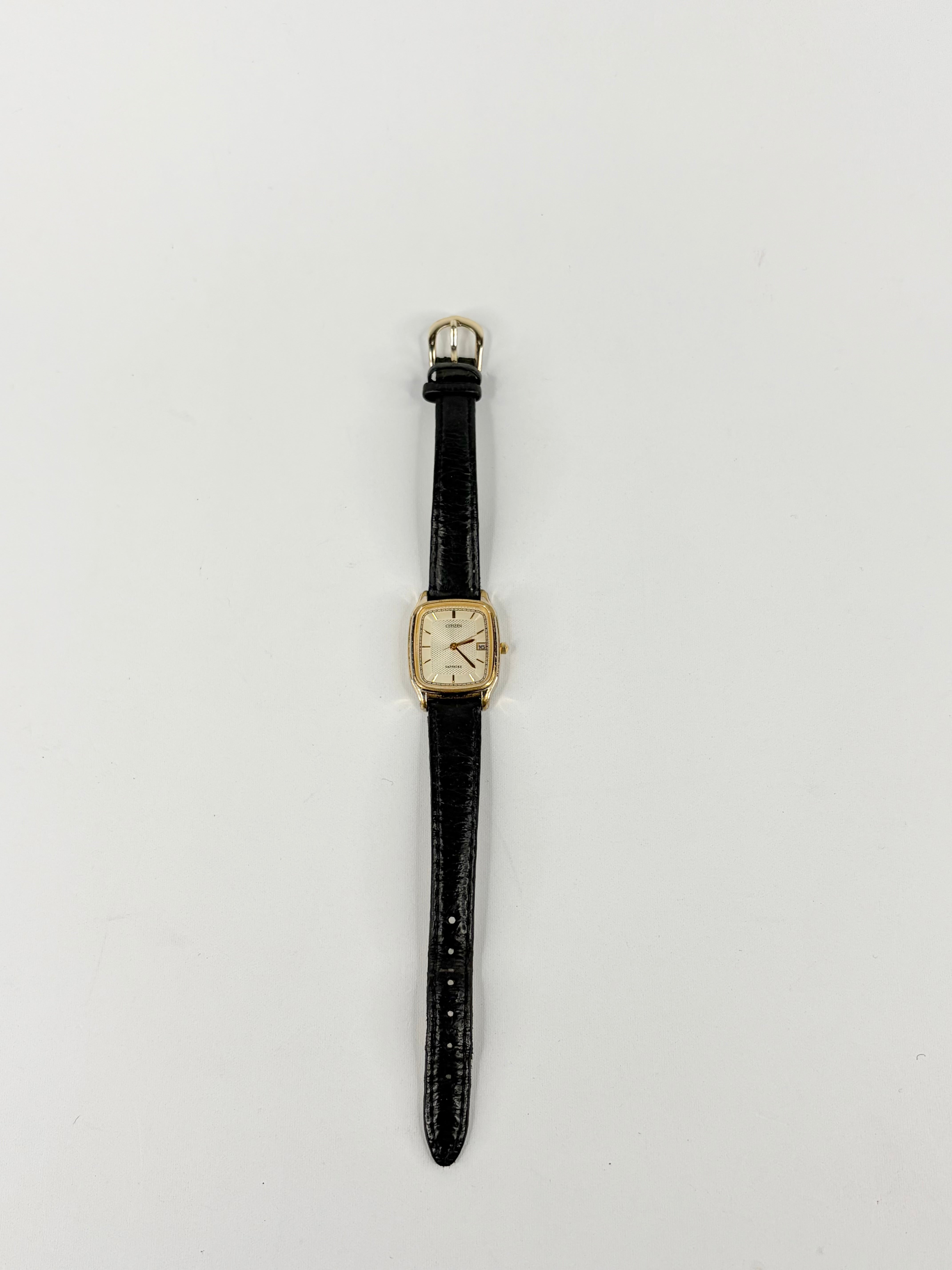 Vintage watch with black strap on a light gray background