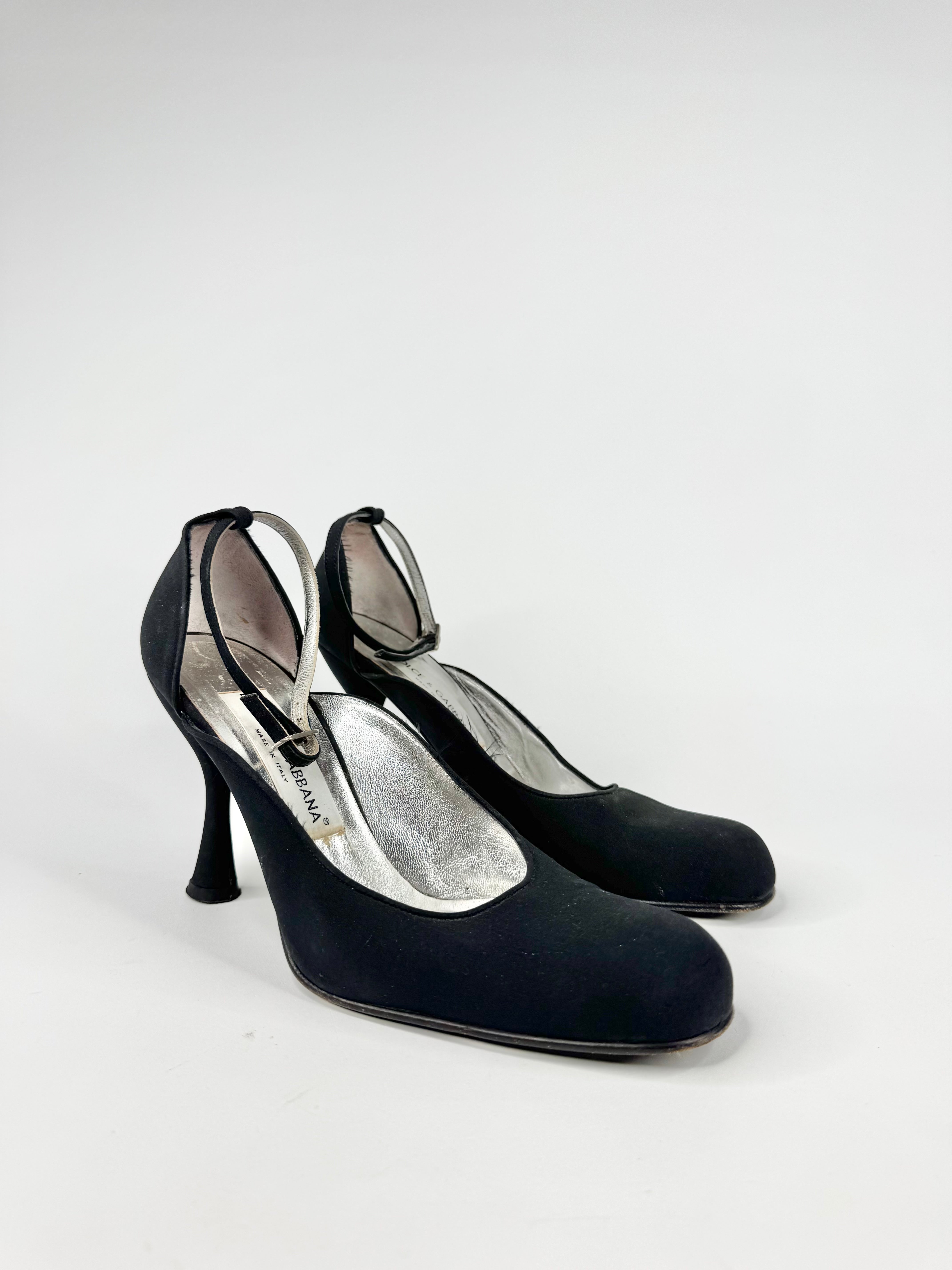 Pair of black high-heeled shoes on a white background