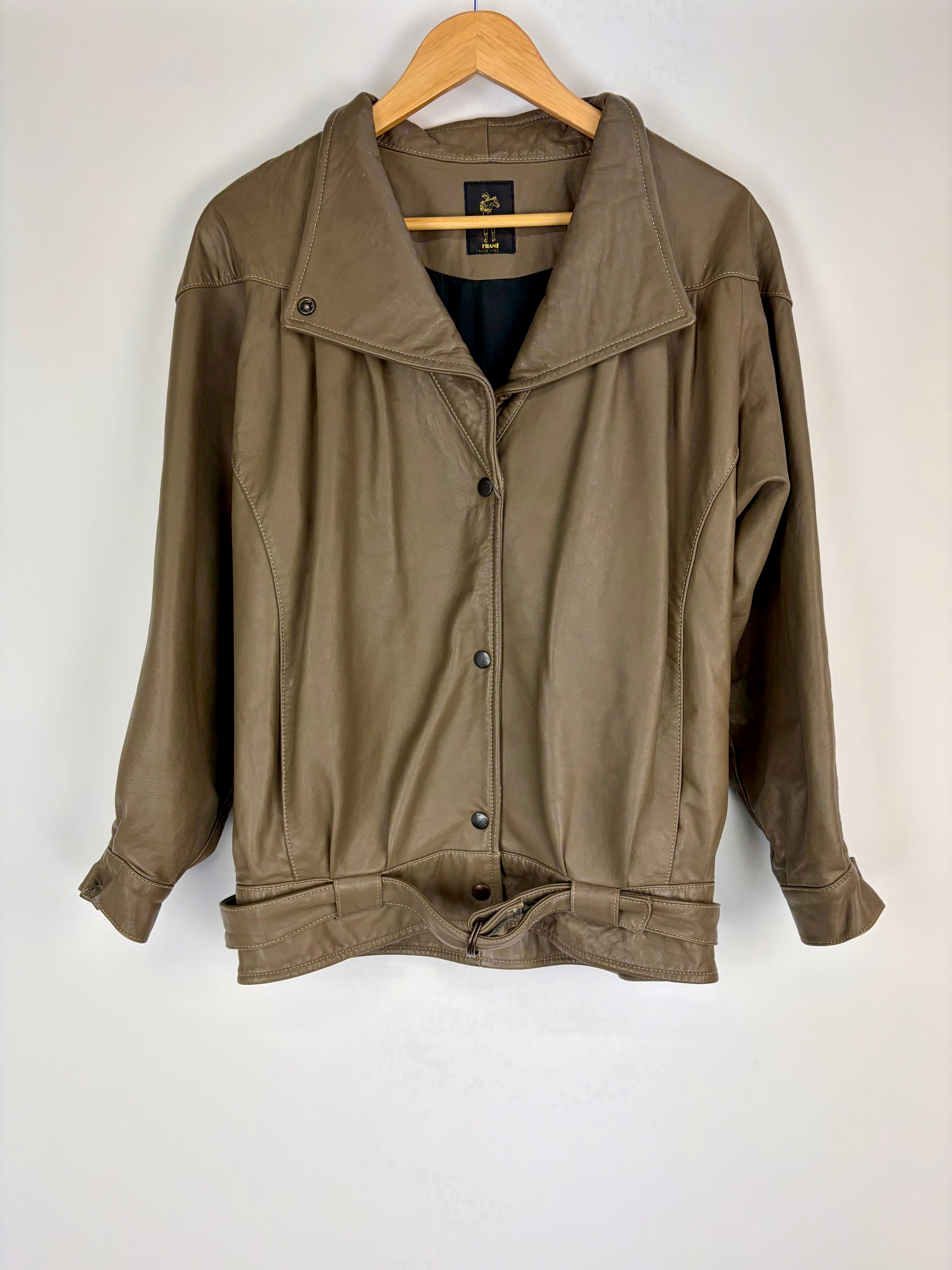 Brown jacket on a wooden hanger against a white background