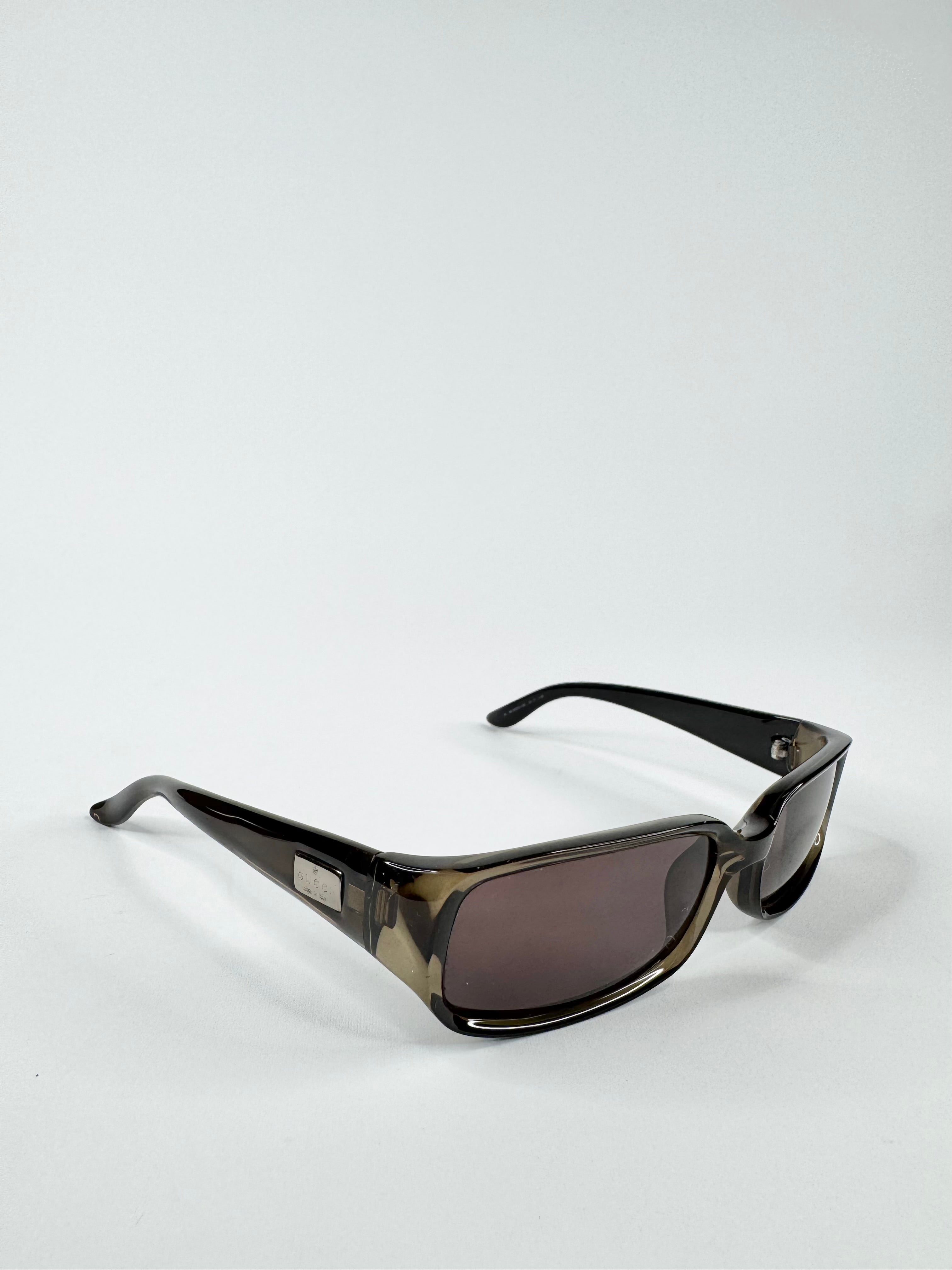 Sunglasses with a black frame and dark lenses on a white background