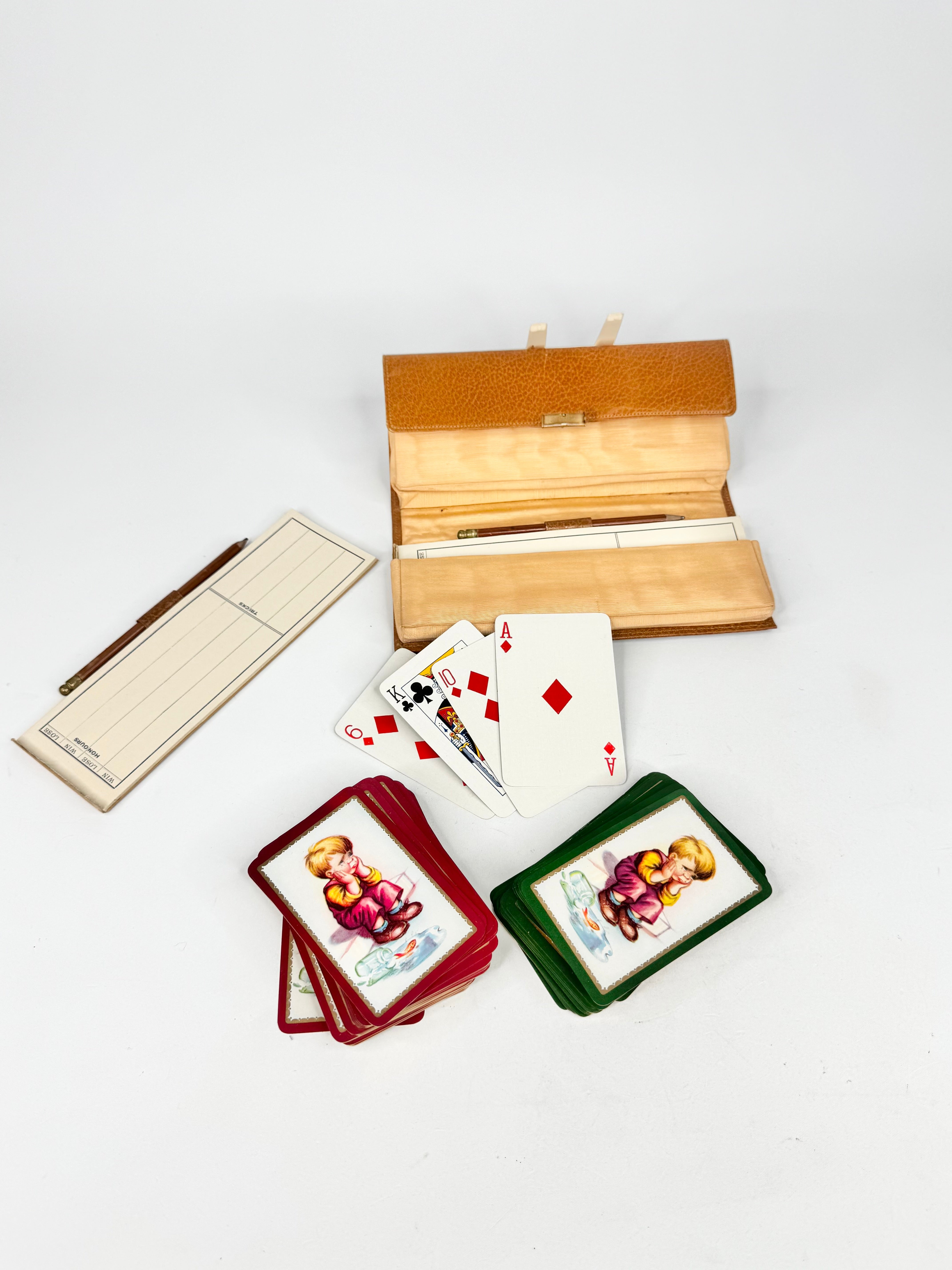 Collection of playing cards and card cases on a white background
